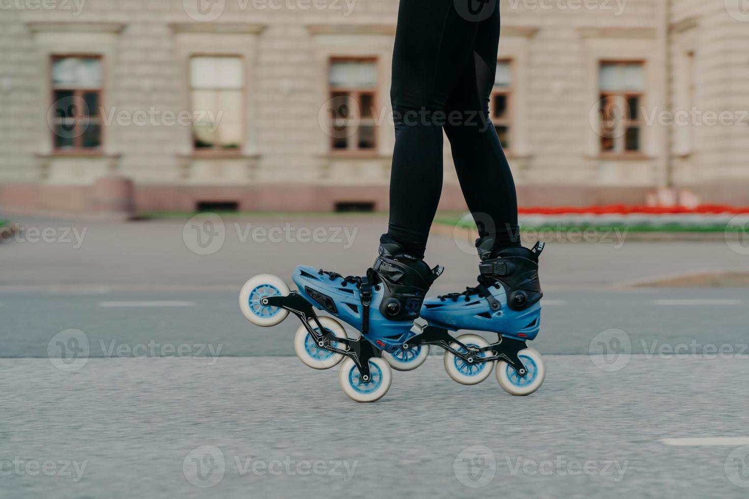 Cropped shot of faceless woman wears rollerblades for riding on road enjoys hobby in fresh air has active lifestyle tries new rollers after purchasing. People hobby and outdoor free time activities photo