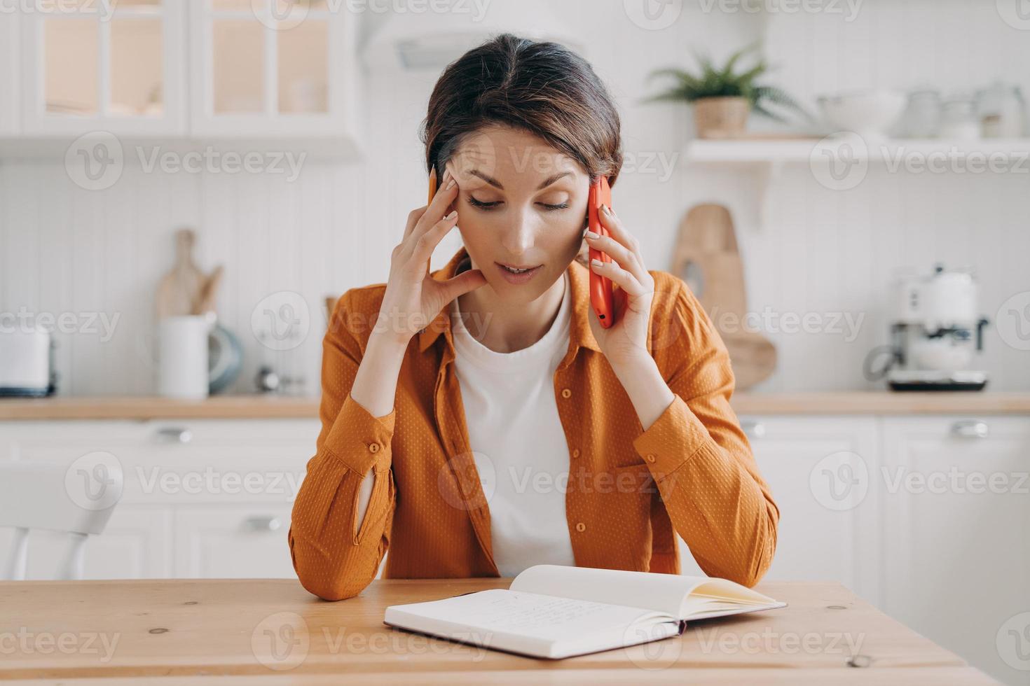 Tired young woman is remote employee working from home. Secretary or office manager. photo