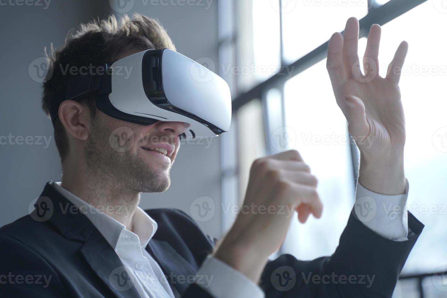 Europian man office employee wears formal suit and VRheadset excited of experiencing virtual reality photo