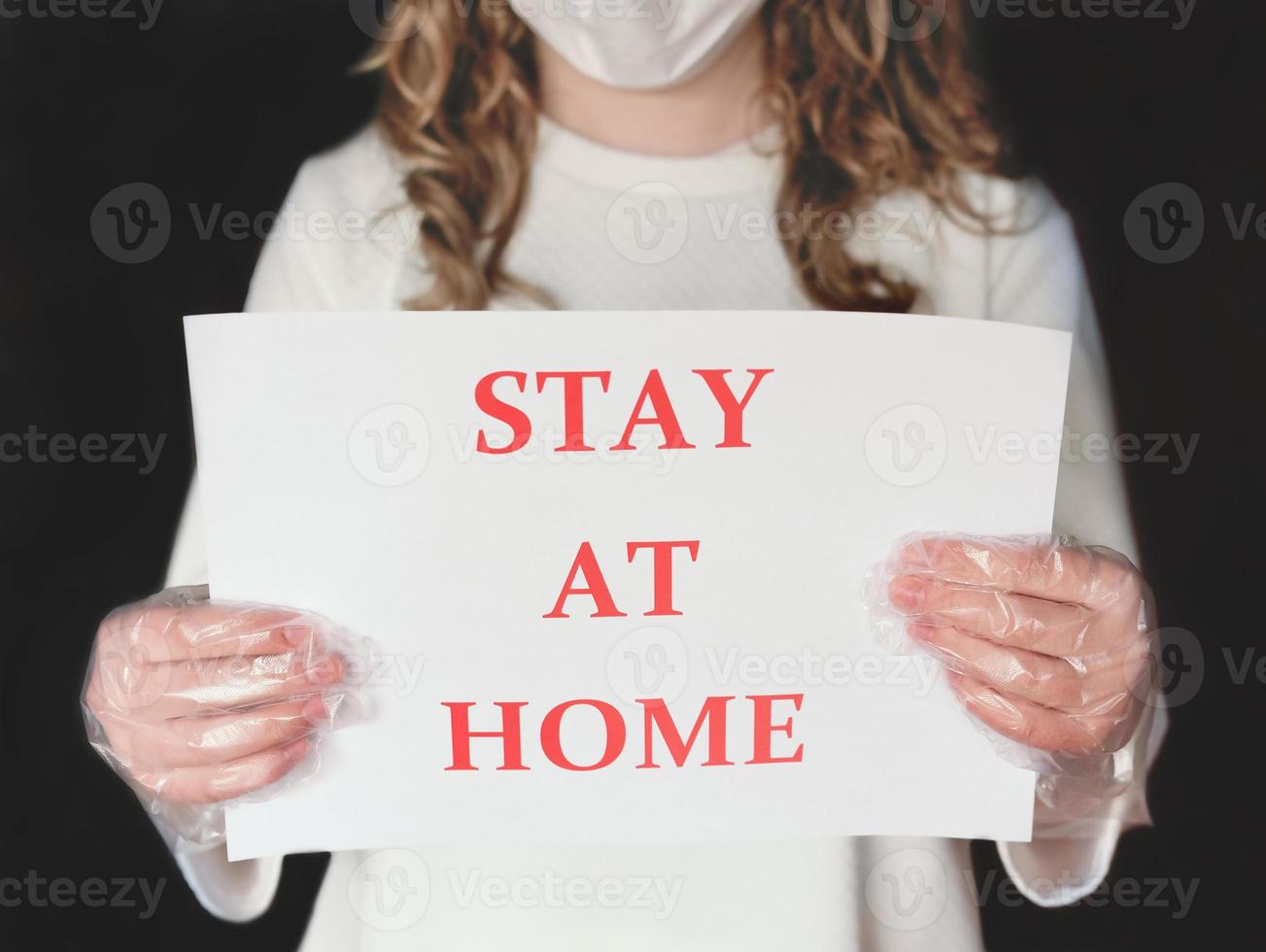 beautiful woman in medical mask holding quarantine warning, outbreak alert notification. pandemic Covid -19 prevention. photo