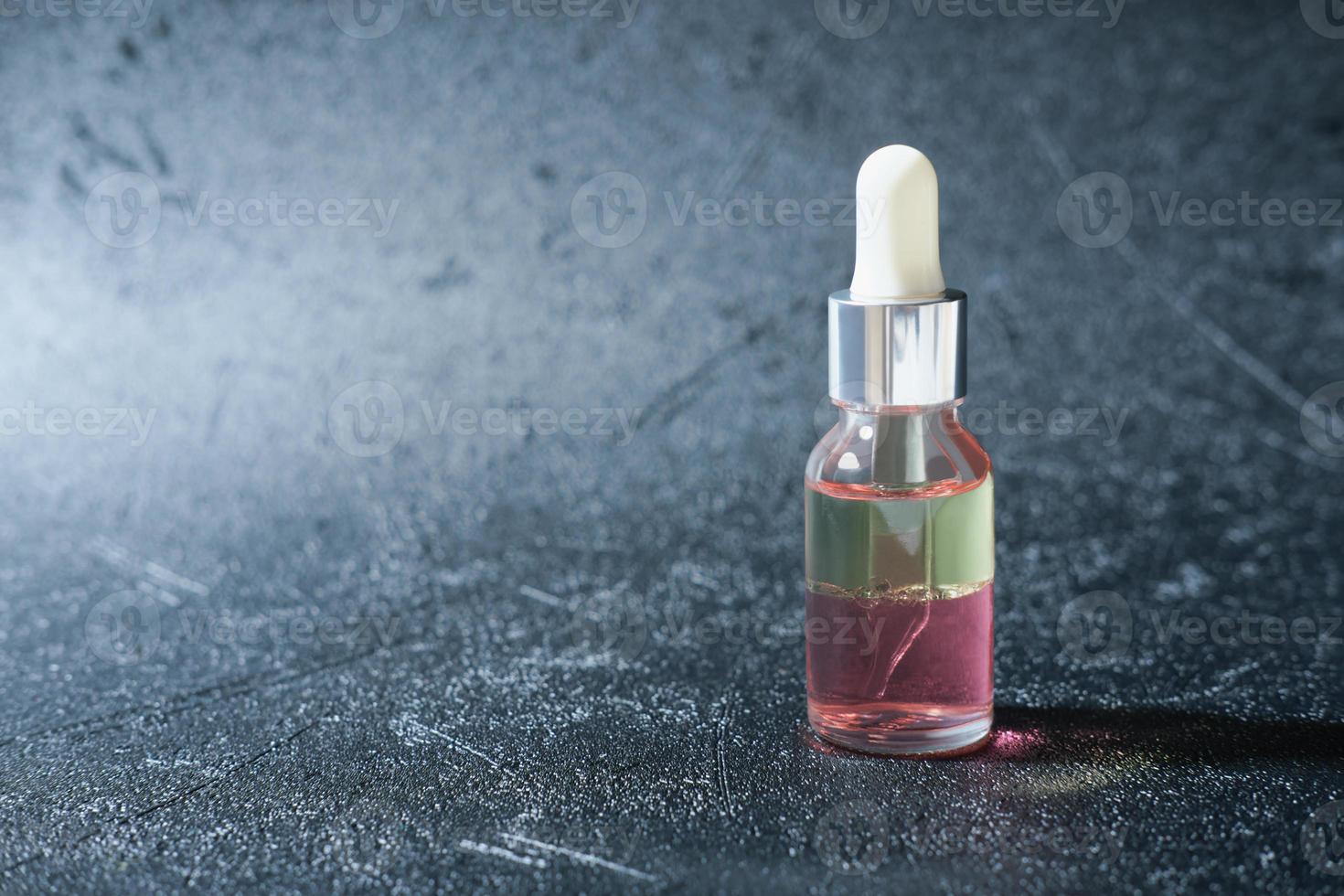 peptides nourishing oil in a glass bottle with dropper. two phase face oil enriched with anti age complex. beauty care concept. wrinkle care unbranded bottle. copy space photo