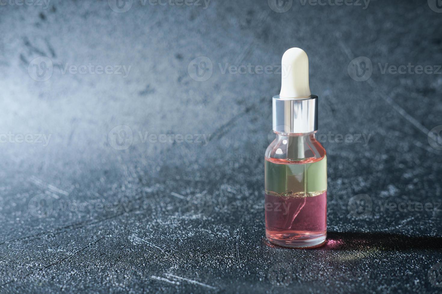 peptides nourishing oil in a glass bottle with dropper. two phase face oil enriched with anti age complex. beauty care concept. wrinkle care unbranded bottle. copy space photo