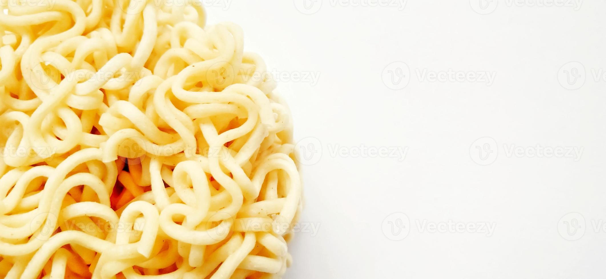 Uncooked instant noodles with negative space isolated on the gray white studio background. Food background design. Suitable for promotion of food and beverage industry and company, food advertising. photo