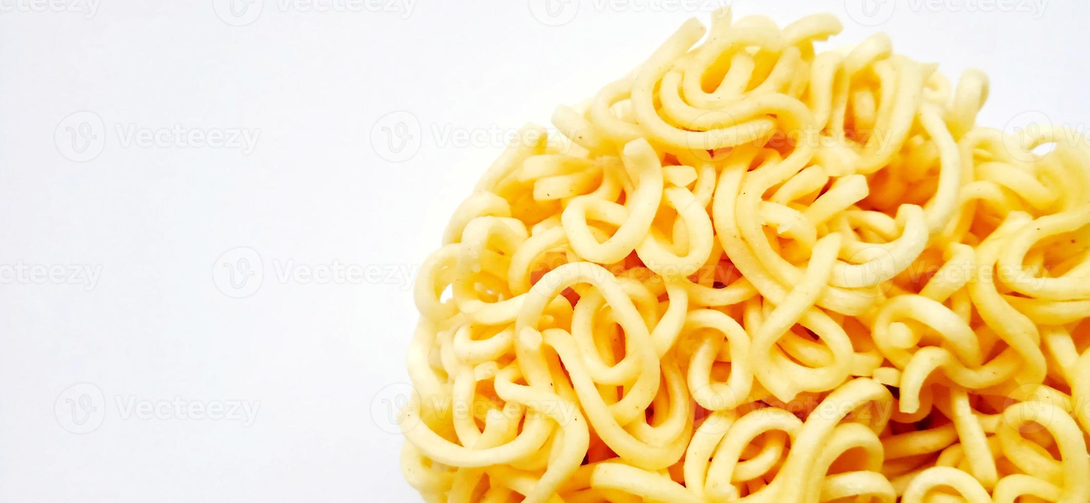 Uncooked instant noodles with negative space isolated on the gray white studio background. Food background design. Suitable for promotion of food and beverage industry and company, food advertising. photo