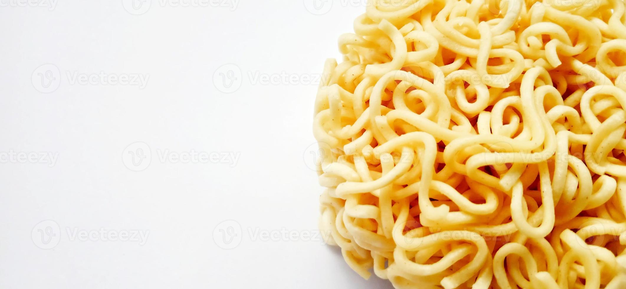 Uncooked instant noodles with negative space isolated on the gray white studio background. Food background design. Suitable for promotion of food and beverage industry and company, food advertising. photo