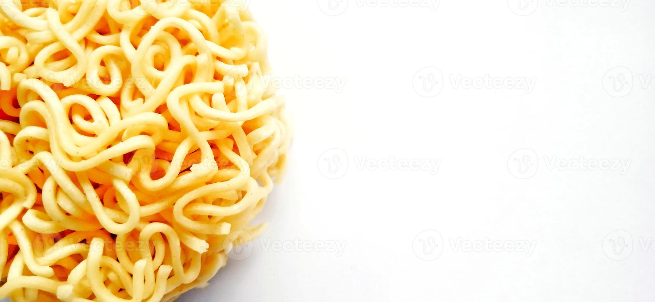 Uncooked instant noodles with negative space isolated on the gray white studio background. Food background design. Suitable for promotion of food and beverage industry and company, food advertising. photo