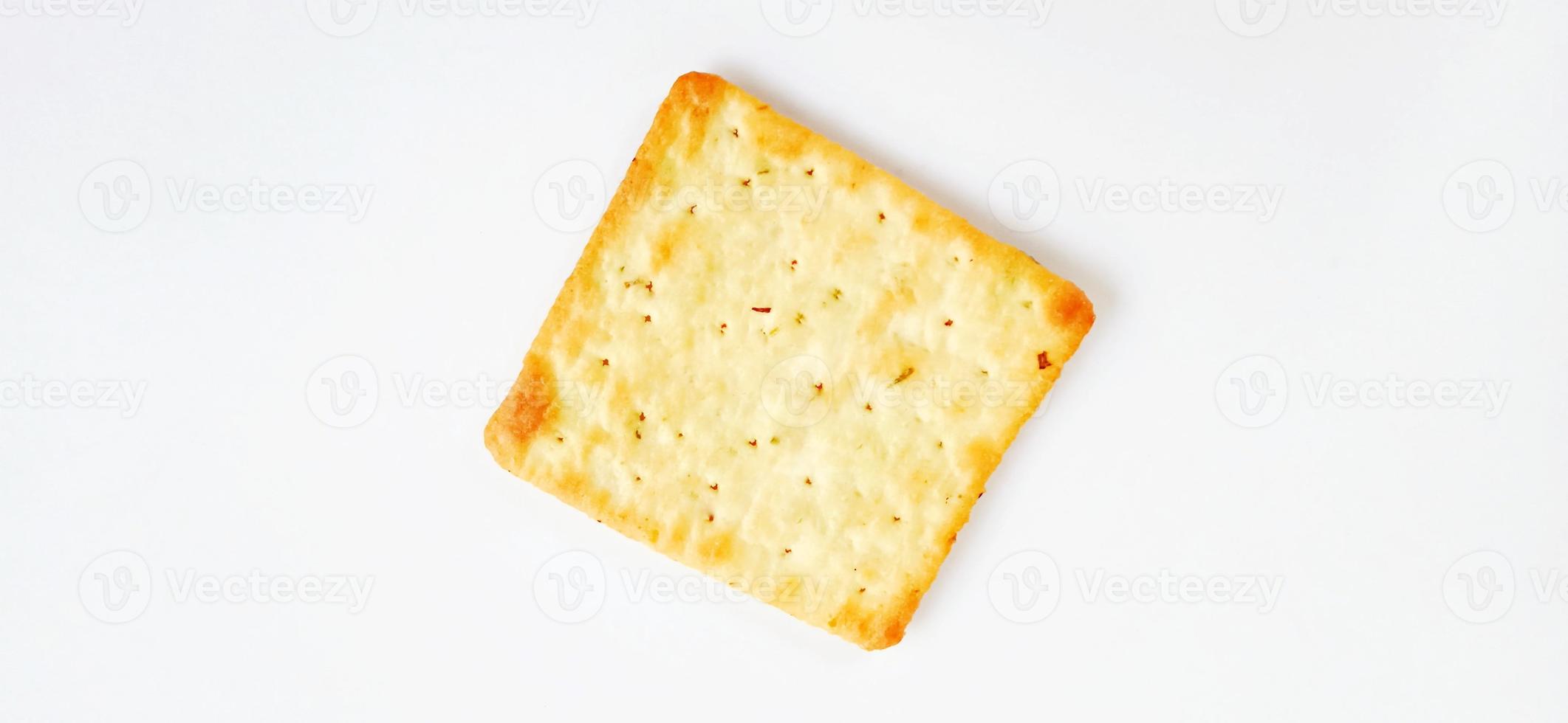 Sugarless and vegetable healthy cracker biscuit slices on the gray white studio background. Food background design. Suitable for promotion of food and beverage industry and company, food advertising. photo