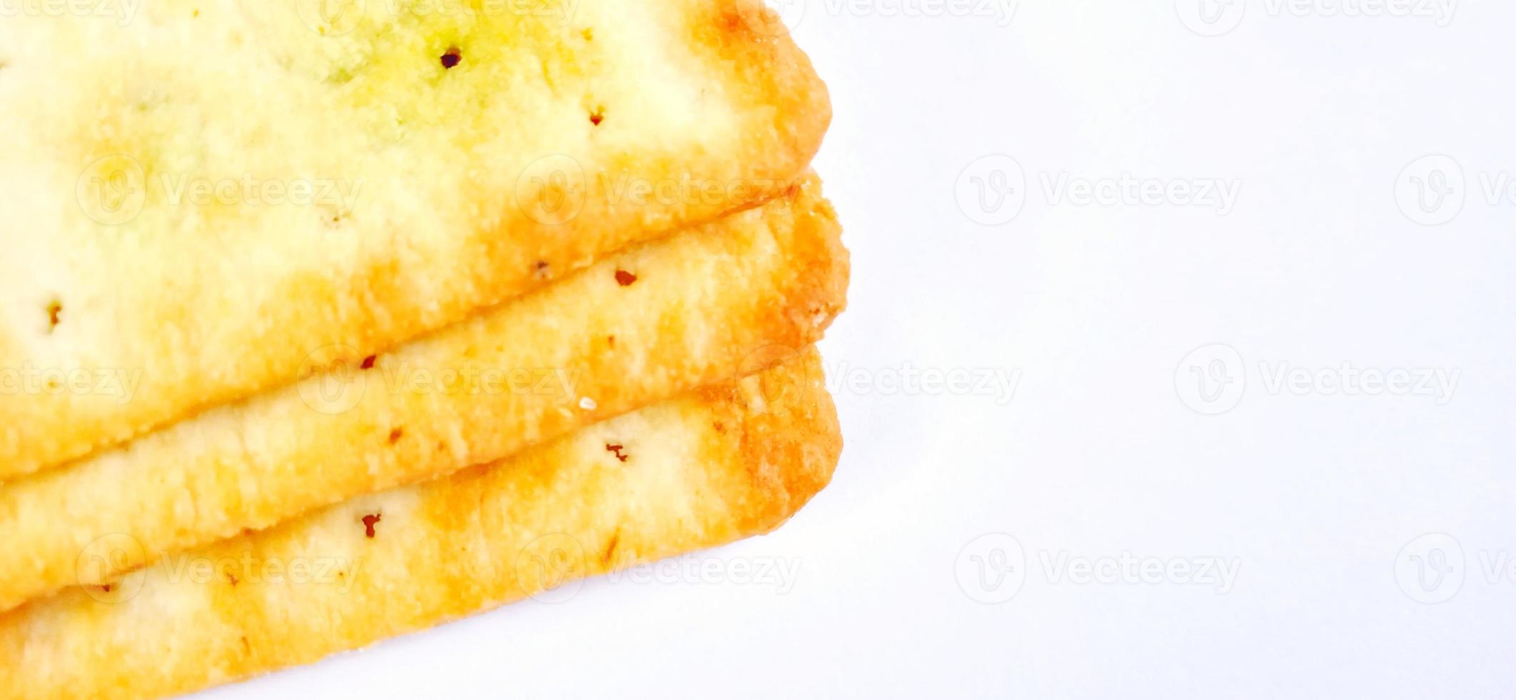Sugarless and vegetable healthy cracker biscuit slices on the gray white studio background. Food background design. Suitable for promotion of food and beverage industry and company, food advertising. photo