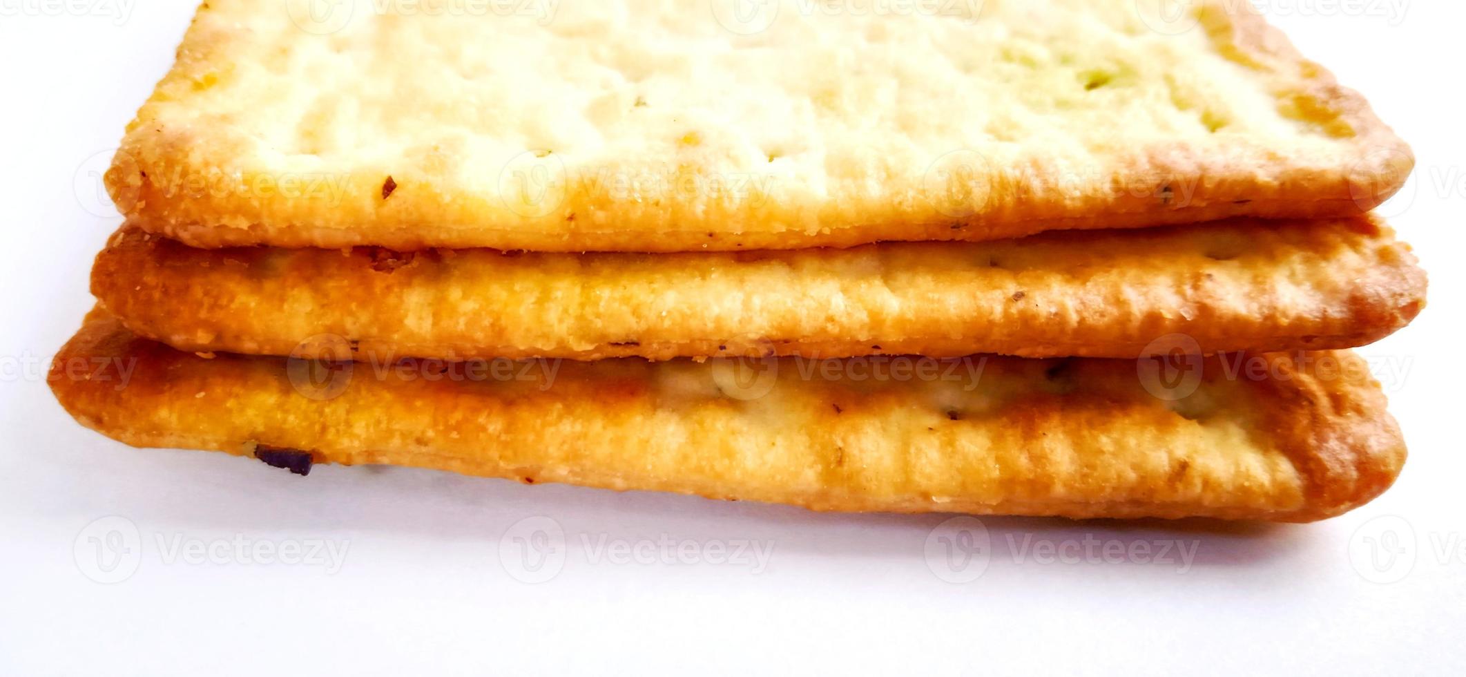 Sugarless and vegetable healthy cracker biscuit slices on the gray white studio background. Food background design. Suitable for promotion of food and beverage industry and company, food advertising. photo