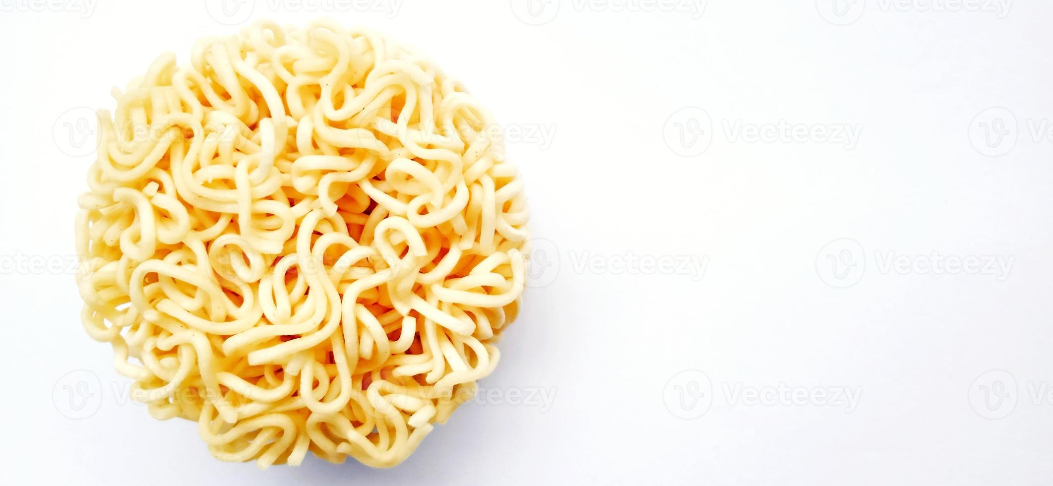 Uncooked instant noodles with negative space isolated on the gray white studio background. Food background design. Suitable for promotion of food and beverage industry and company, food advertising. photo