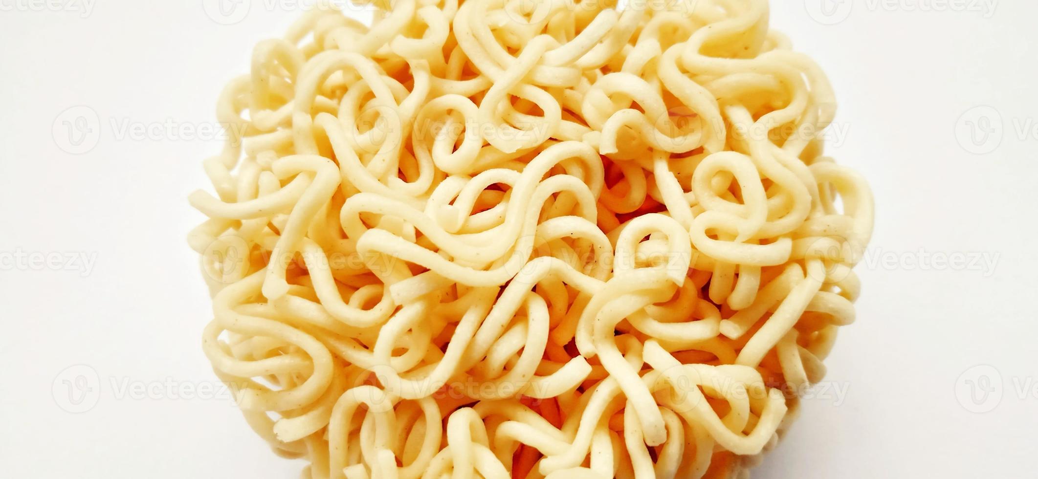 Uncooked instant noodles with negative space isolated on the gray white studio background. Food background design. Suitable for promotion of food and beverage industry and company, food advertising. photo