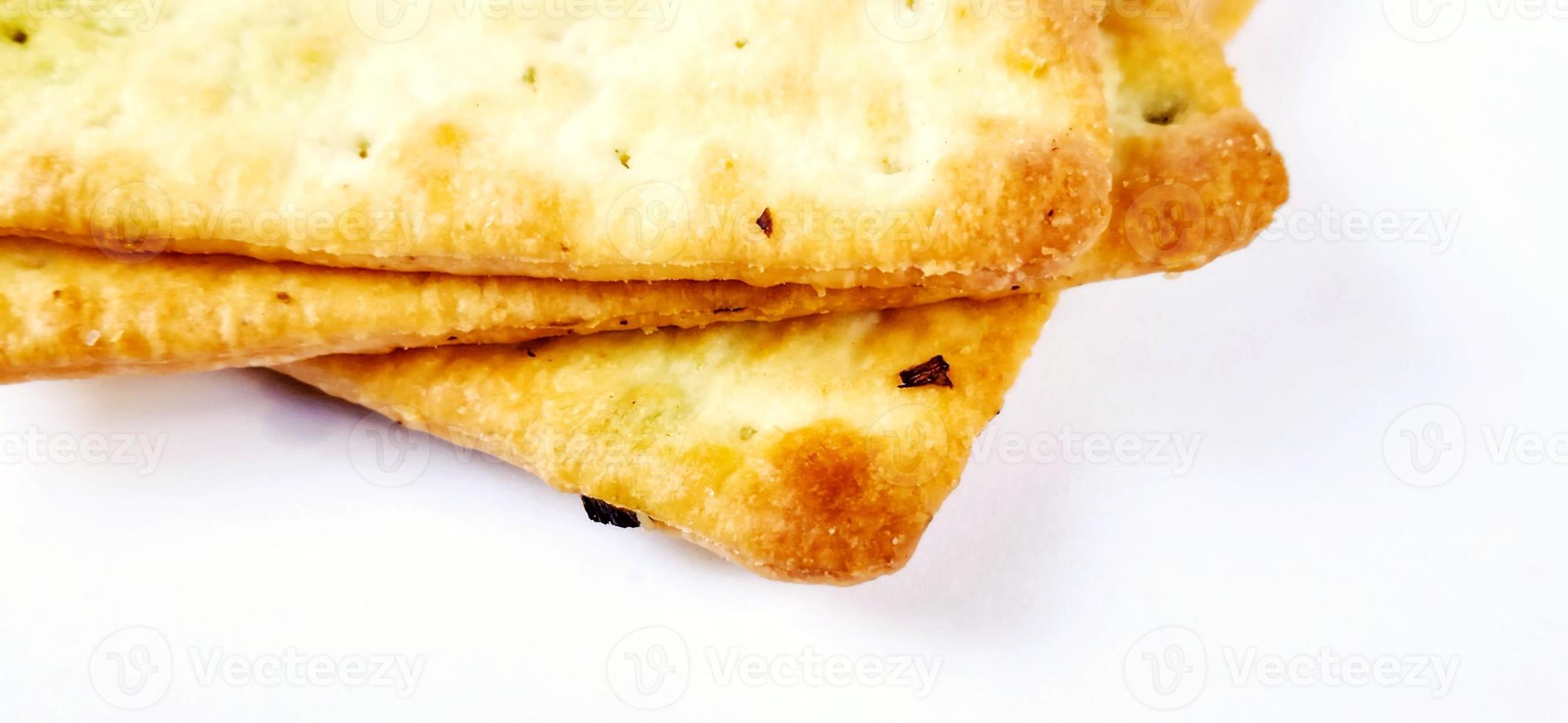 Sugarless and vegetable healthy cracker biscuit slices on the gray white studio background. Food background design. Suitable for promotion of food and beverage industry and company, food advertising. photo