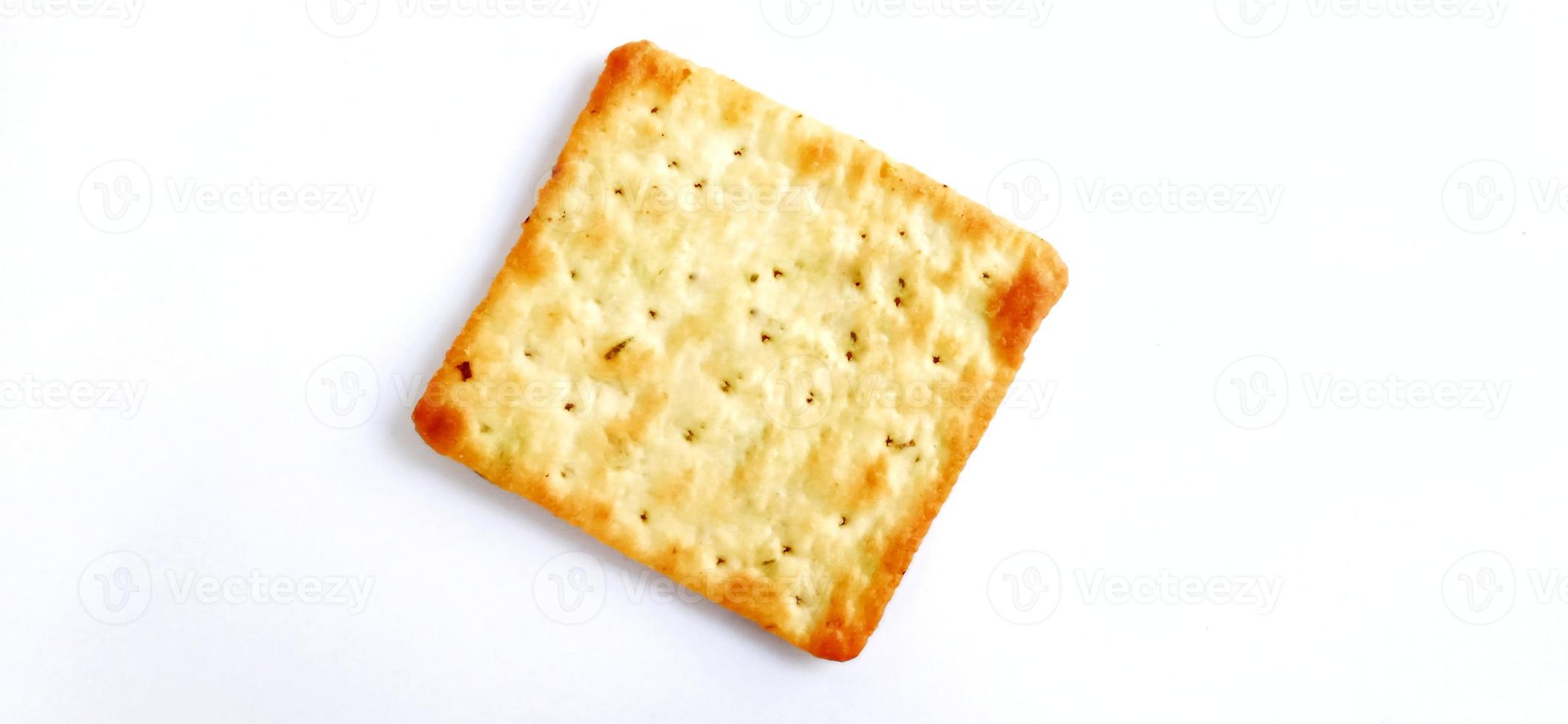 Sugarless and vegetable healthy cracker biscuit slices on the gray white studio background. Food background design. Suitable for promotion of food and beverage industry and company, food advertising. photo