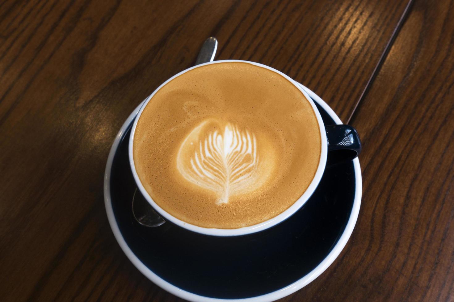 Hot coffee latte on a wooden table photo