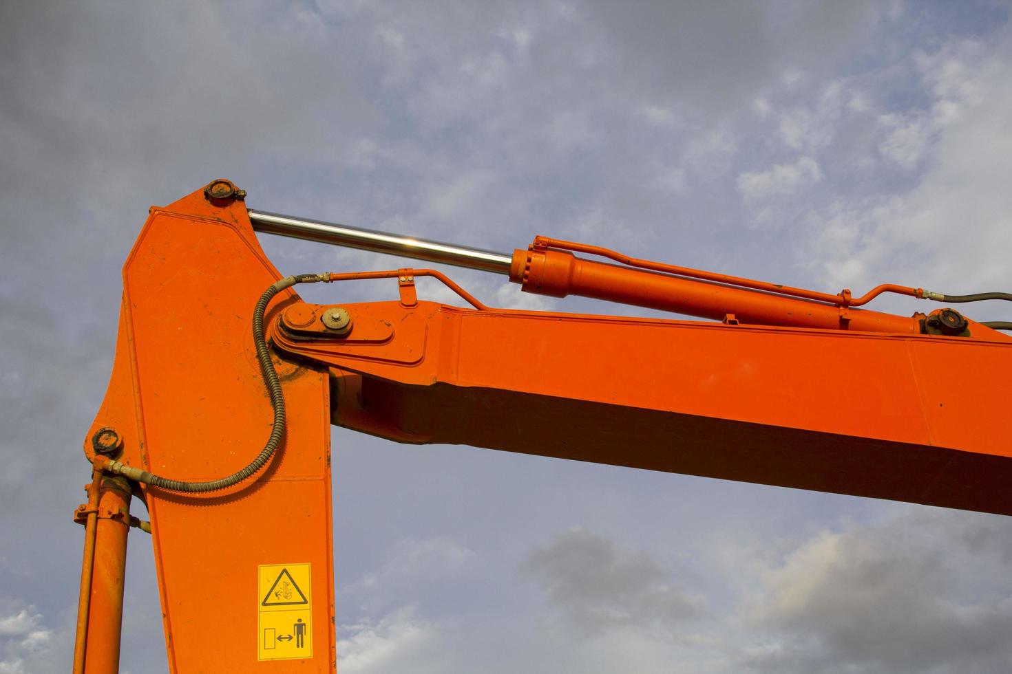 Excavators are stationary after work in the evening, using the arms of the car as a frame to see the beautiful sky and clouds of various colors in the evening, a beam of light into the beautiful river photo