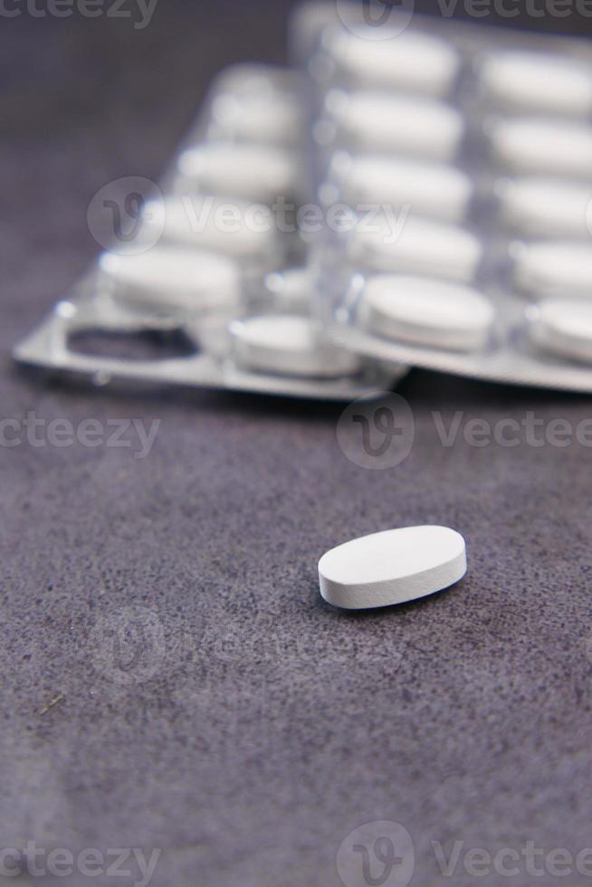 Close up of pills of blister pack on table photo