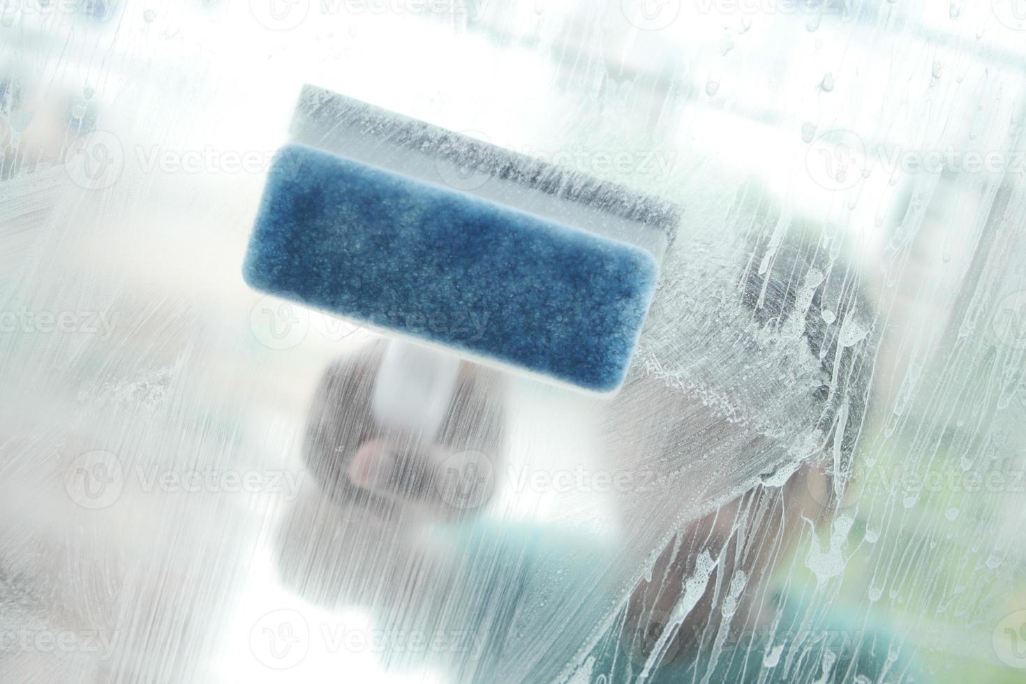 Close up of man hand cleaning window glass photo