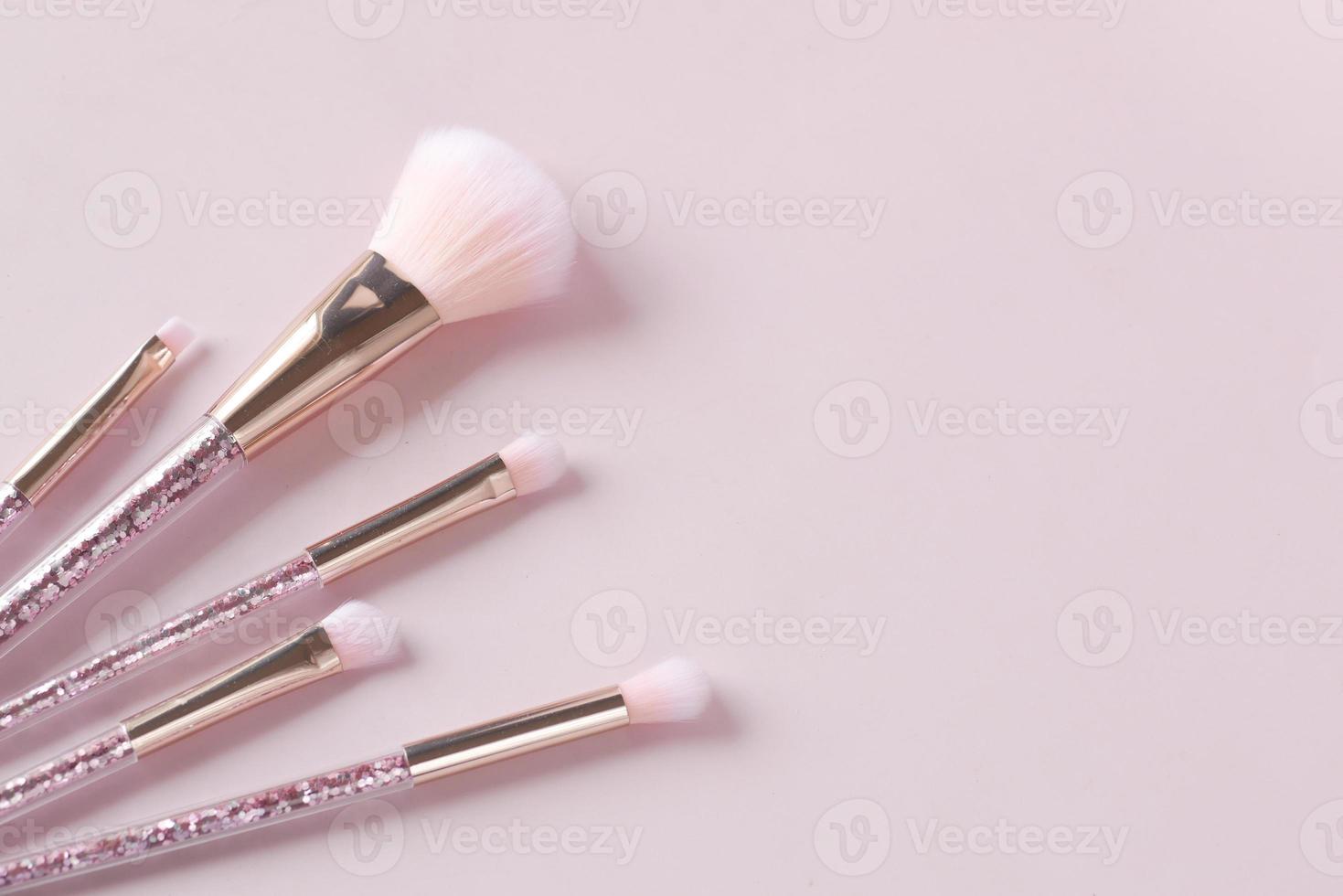 beauty brush on light pink background photo