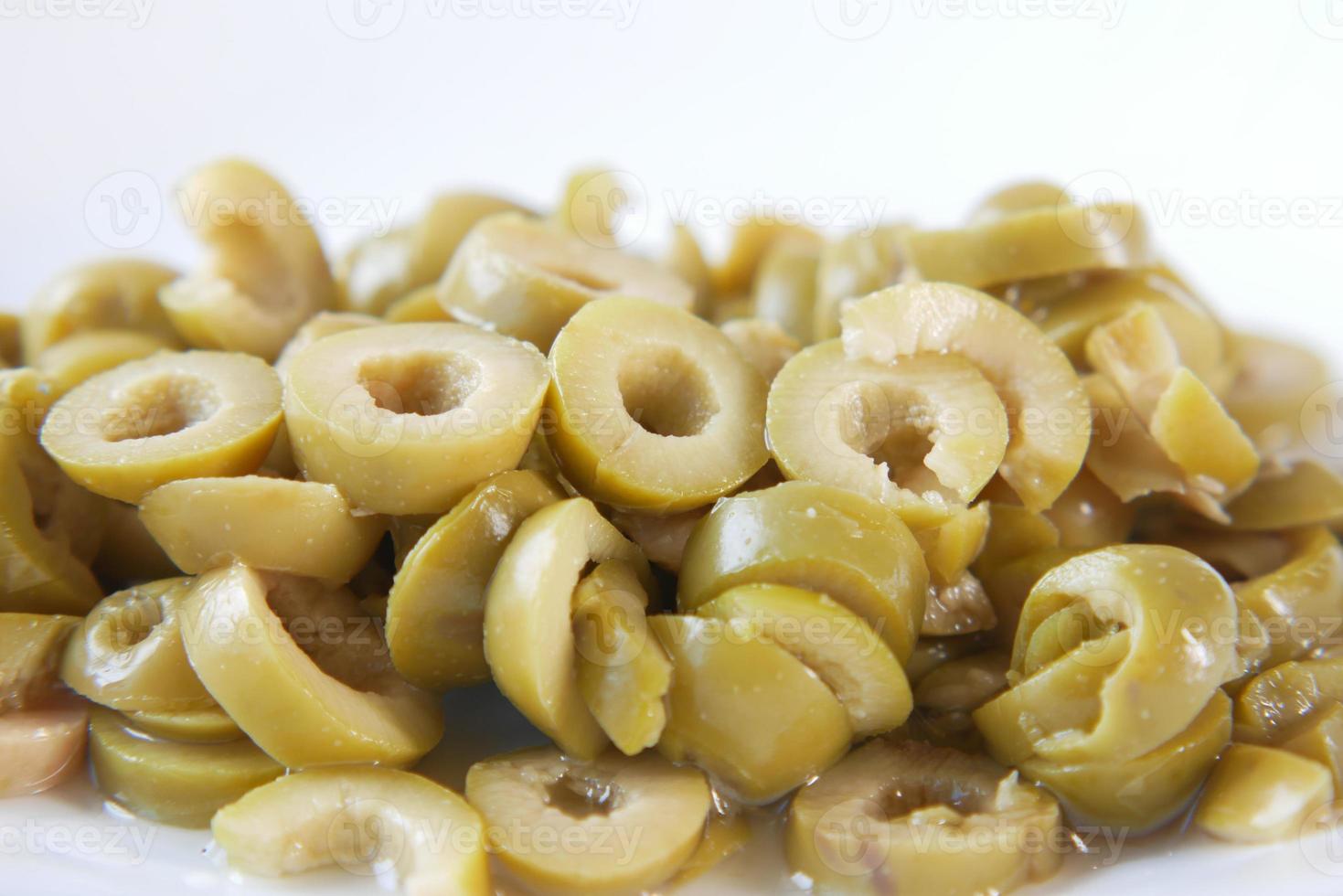 close up of slice of olives on white background photo