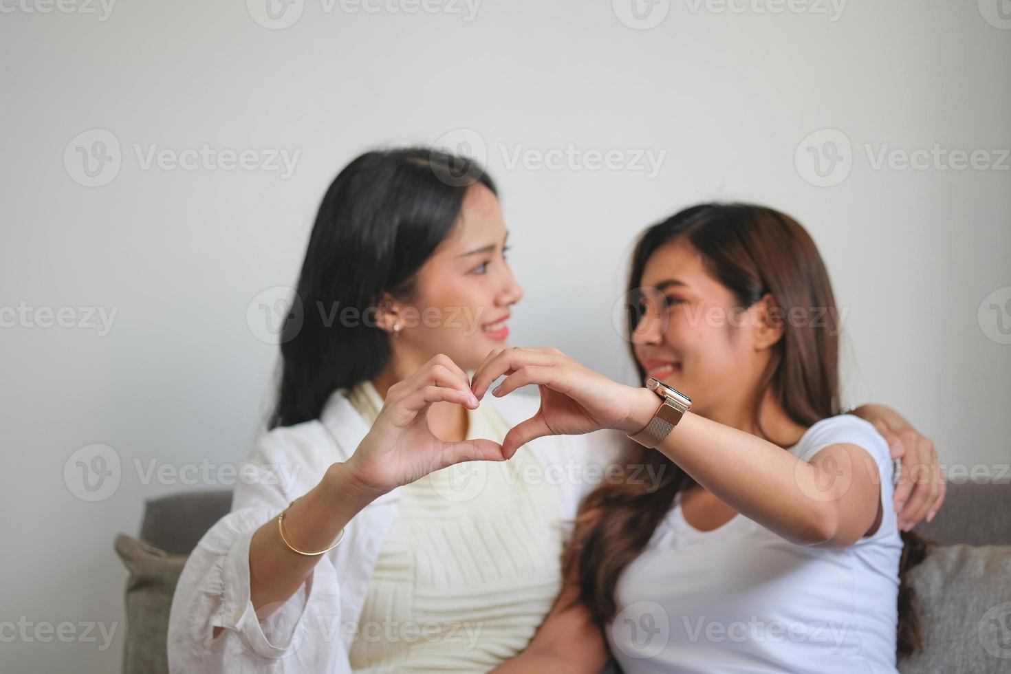 lgbtq, lgbt concept, homosexuality, two beautiful women showing their love to each other in a very warm home happily photo