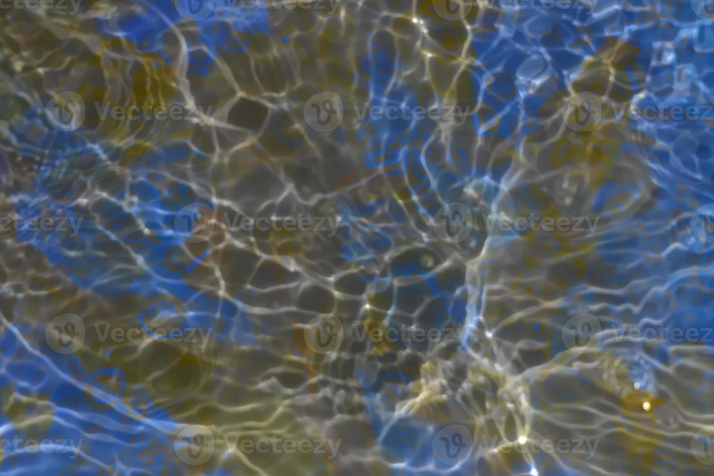 Defocus blurred transparent colorful water splash. Clear calm water surface texture with splashes and bubbles. Trendy abstract nature background. Water waves in sunlight. photo