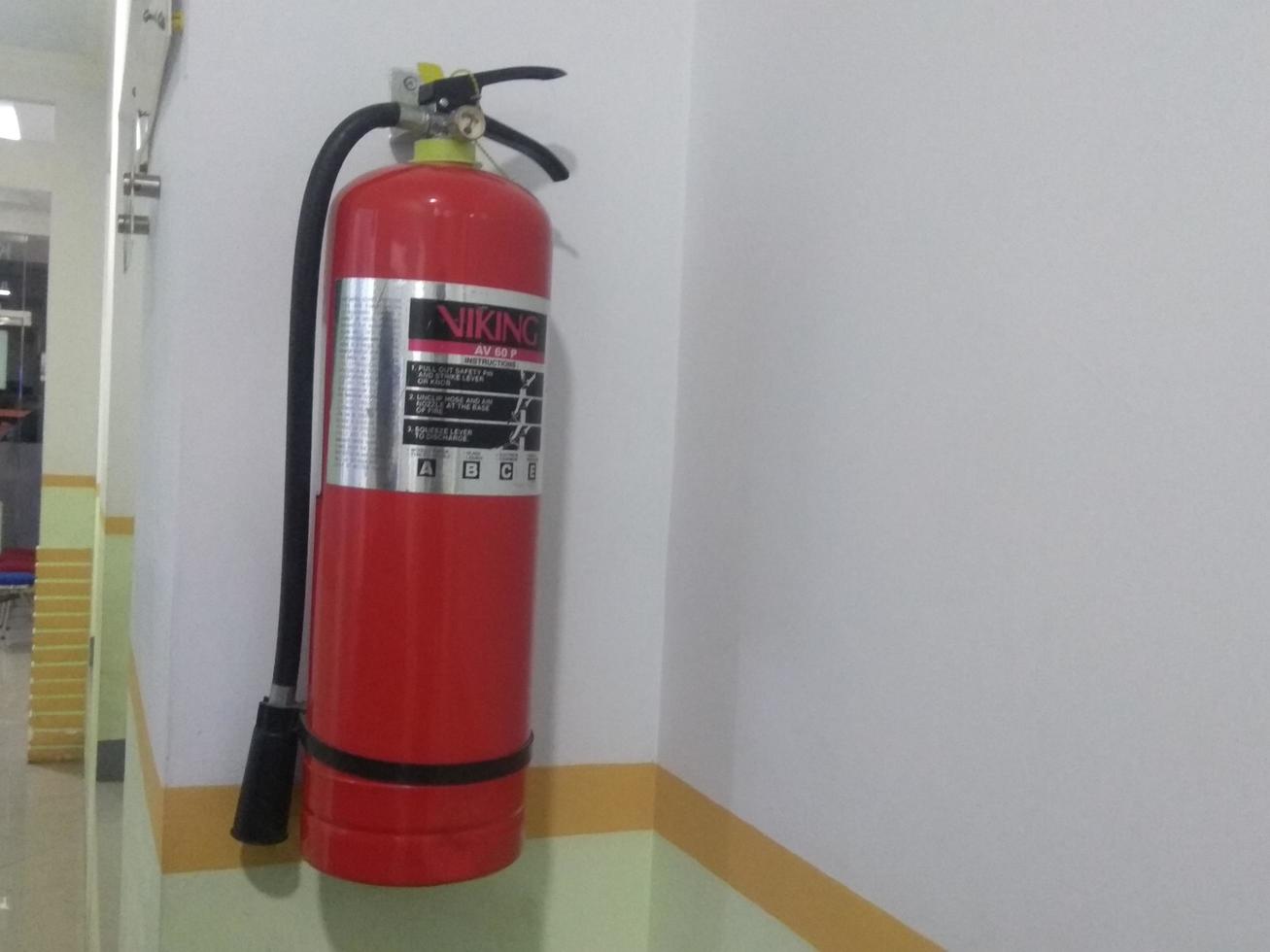 fire extinguisher hanging on the wall photo