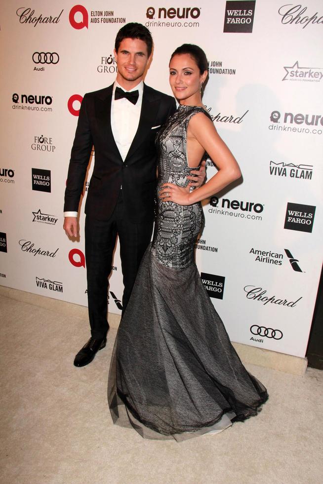 LOS ANGELES, FEB 22 - Robbie Amell, Italia Ricci at the Elton John Oscar Party 2015 at the City Of West Hollywood Park on February 22, 2015 in West Hollywood, CA photo
