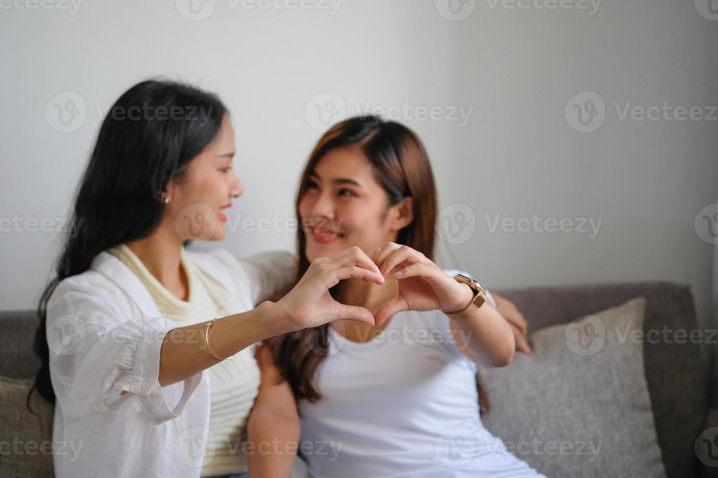 lgbtq, lgbt concept, homosexuality, two beautiful women showing their love to each other in a very warm home happily photo