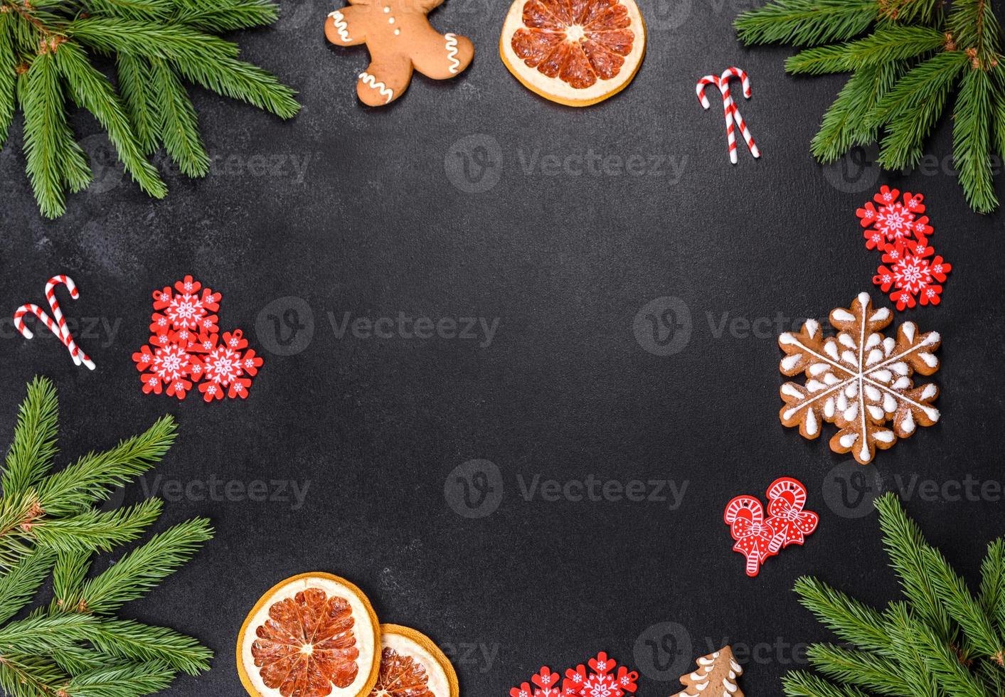 Festive Christmas table with appliances, gingerbreads, tree branches and dried citrus trees photo