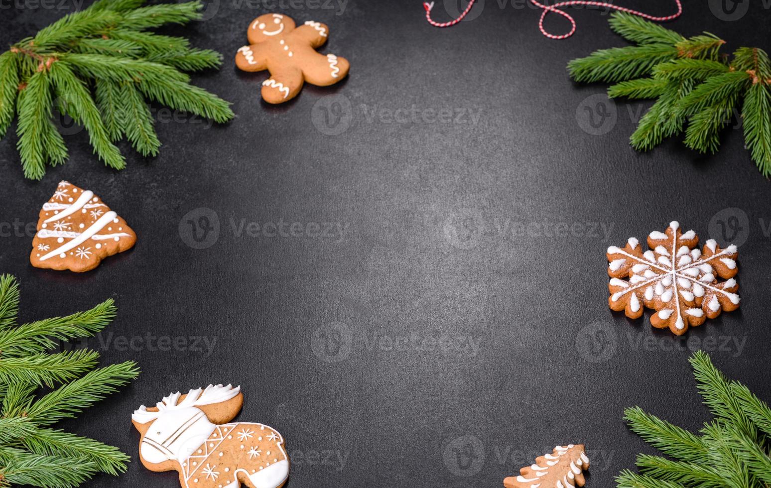 Festive Christmas table with appliances, gingerbreads, tree branches and dried citrus trees photo