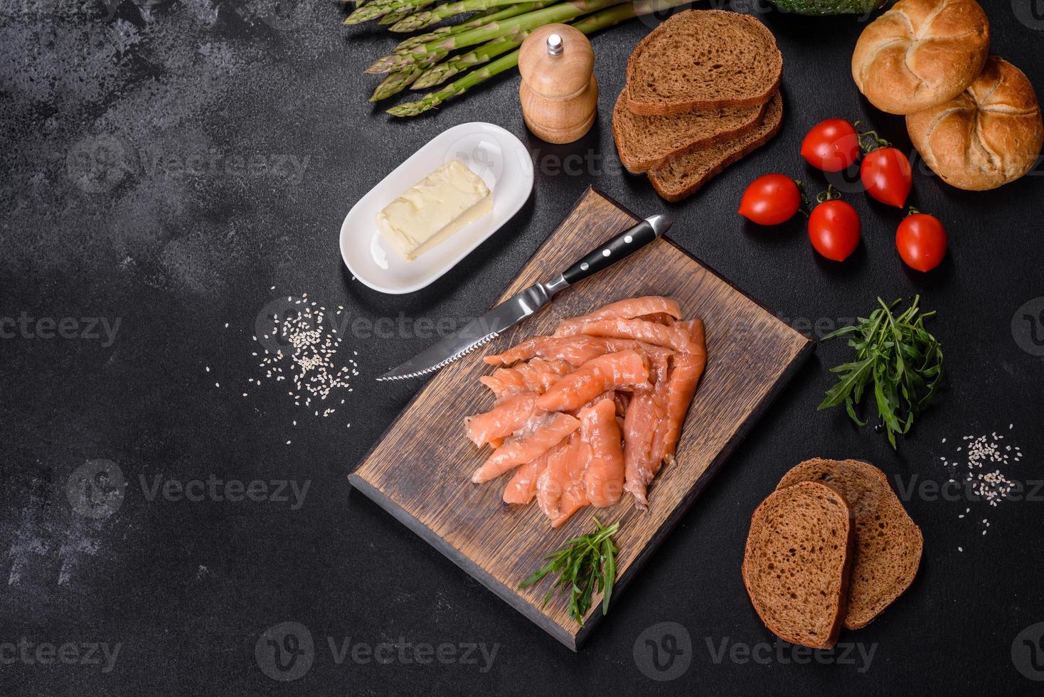 hermosas y deliciosas rodajas de pescado rojo en una tabla de cortar de madera foto