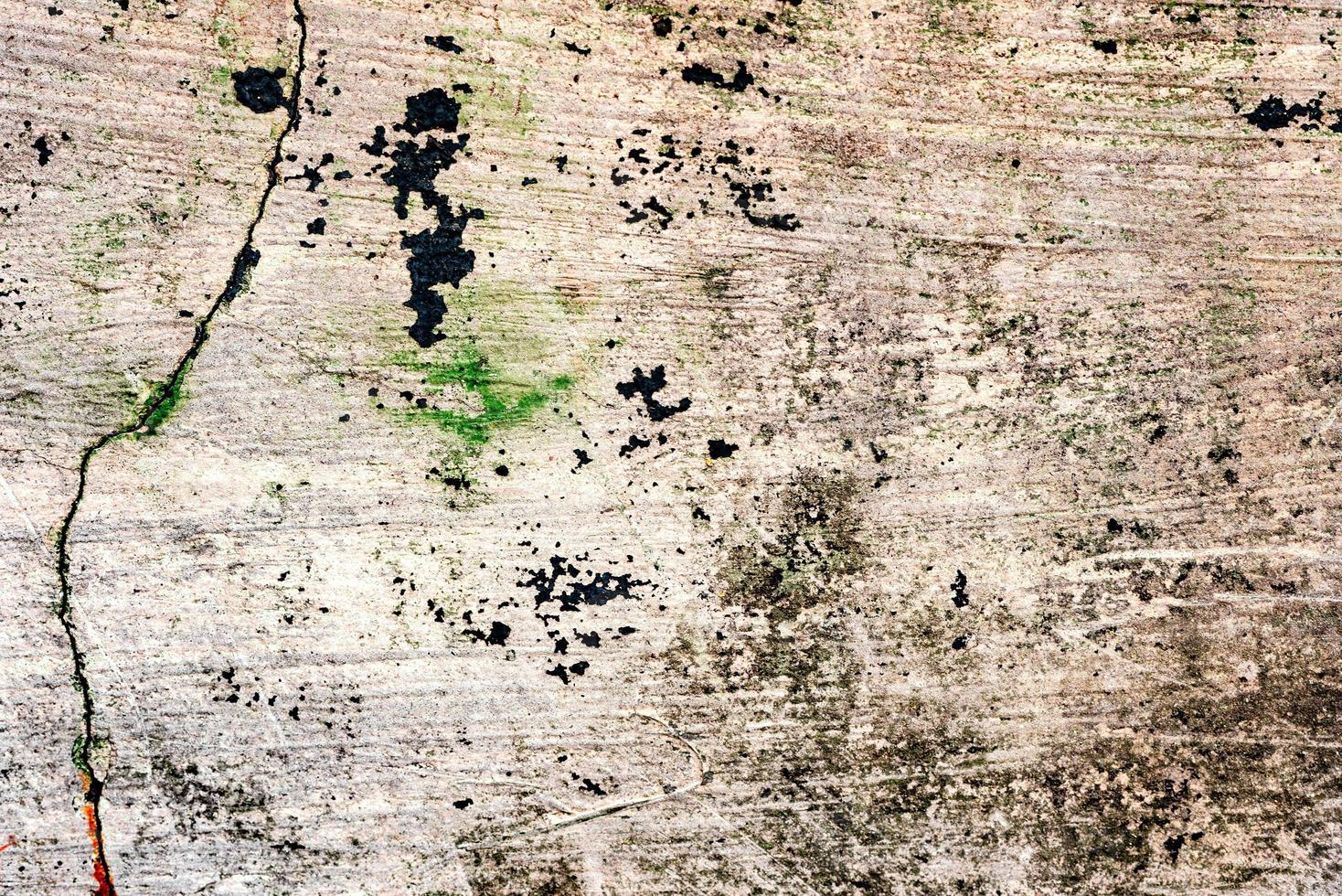 Texture of a concrete wall with cracks and scratches which can be used as a background photo