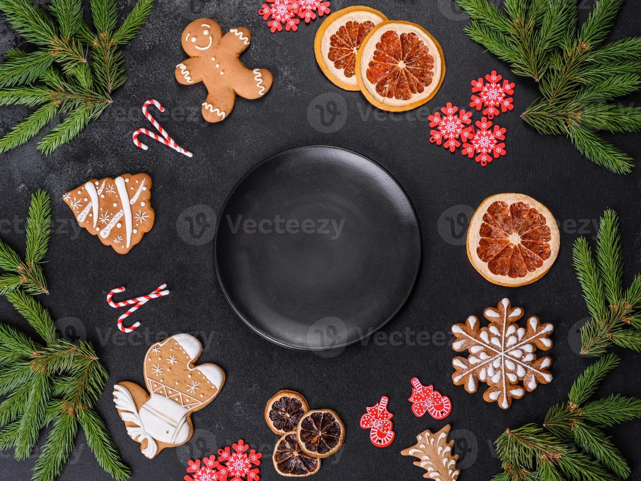 Festive Christmas table with appliances, gingerbreads, tree branches and dried citrus trees photo