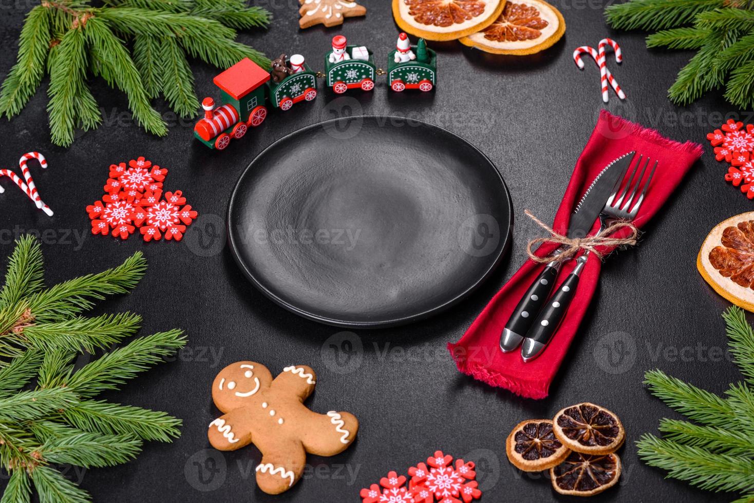 Festive Christmas table with appliances, gingerbreads, tree branches and dried citrus trees photo