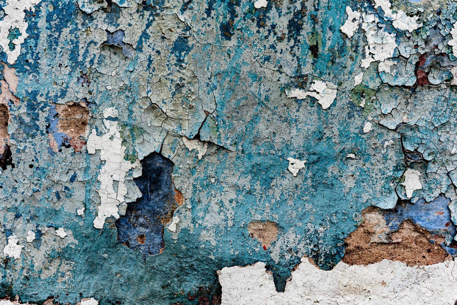 Texture of a concrete wall with cracks and scratches which can be used as a background photo