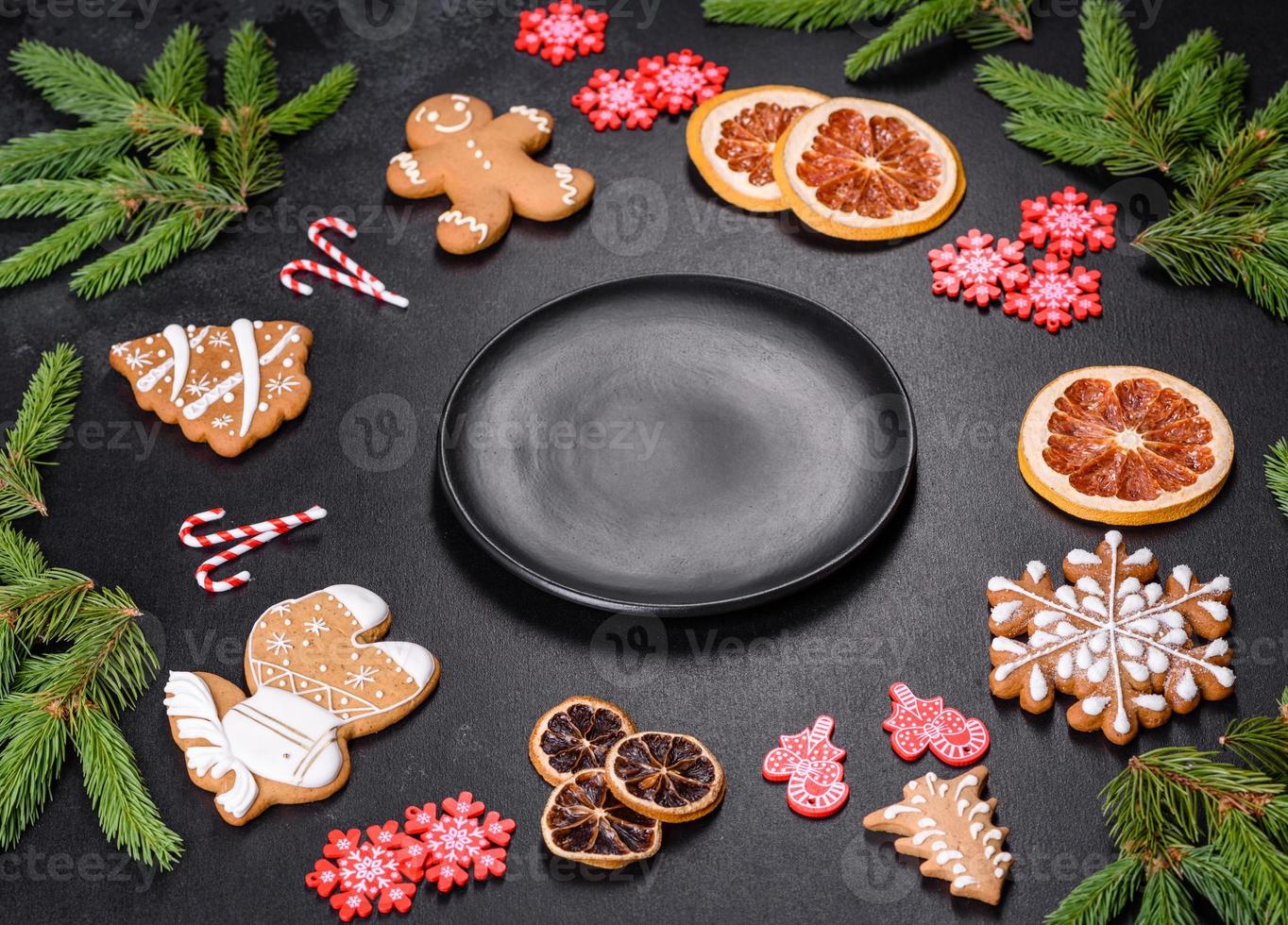 Festive Christmas table with appliances, gingerbreads, tree branches and dried citrus trees photo