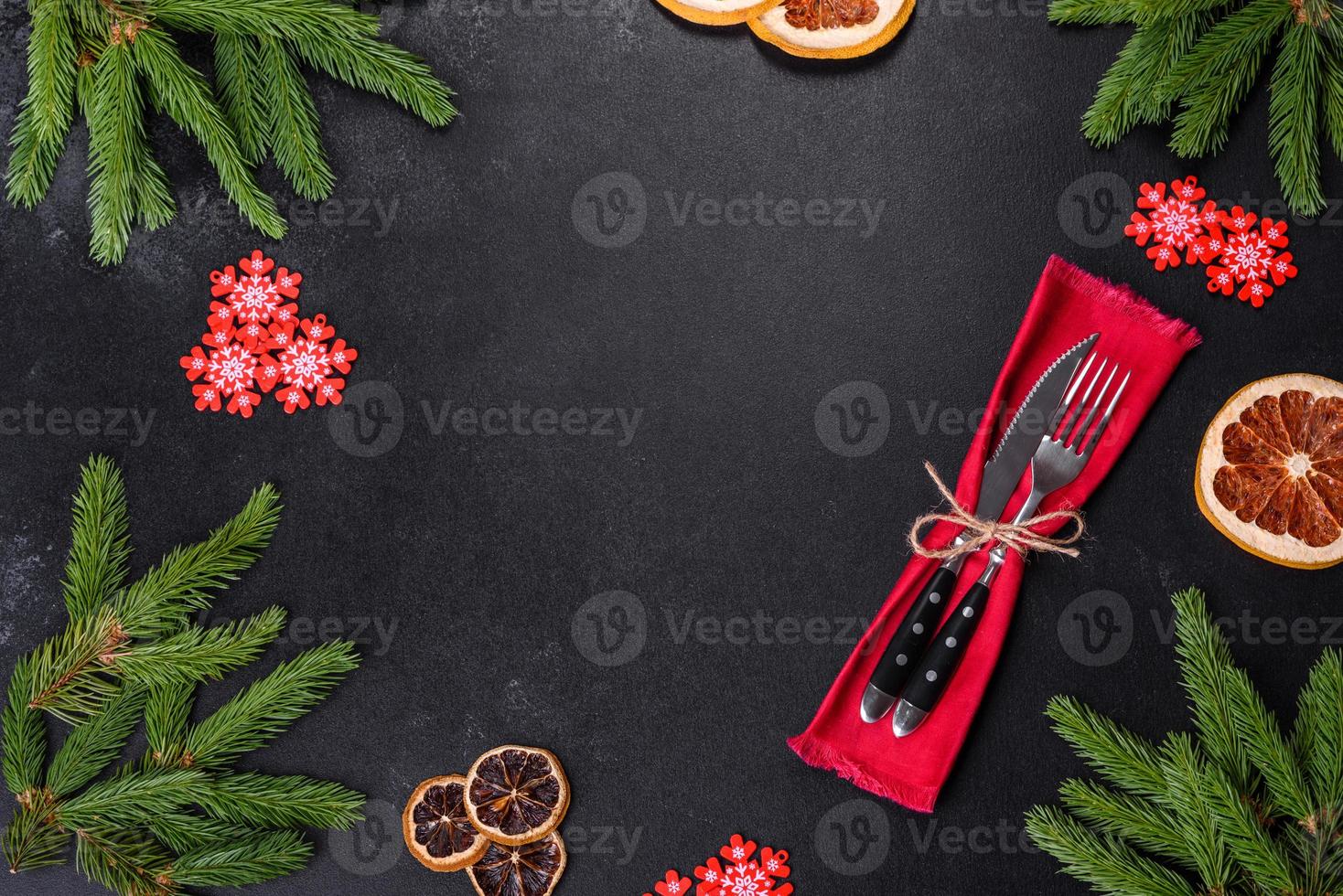 Festive Christmas table with appliances, gingerbreads, tree branches and dried citrus trees photo