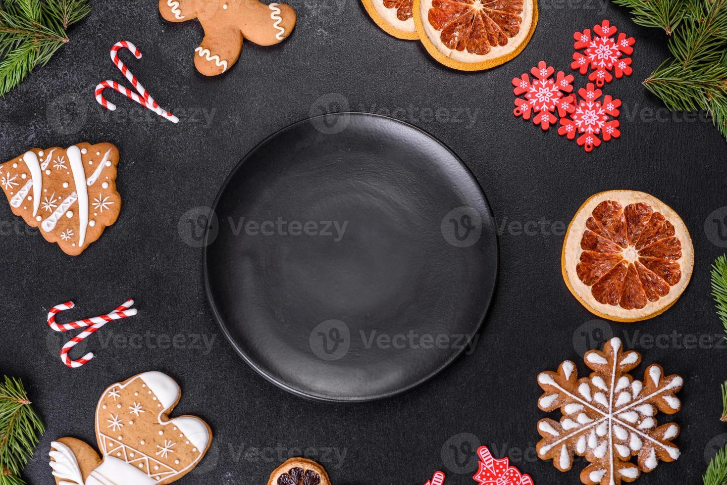 Festive Christmas table with appliances, gingerbreads, tree branches and dried citrus trees photo