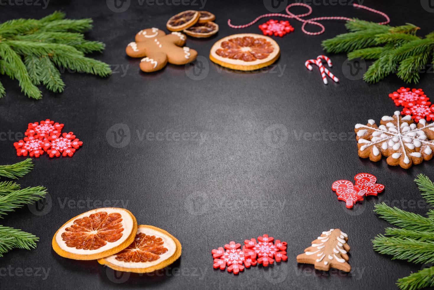 Festive Christmas table with appliances, gingerbreads, tree branches and dried citrus trees photo