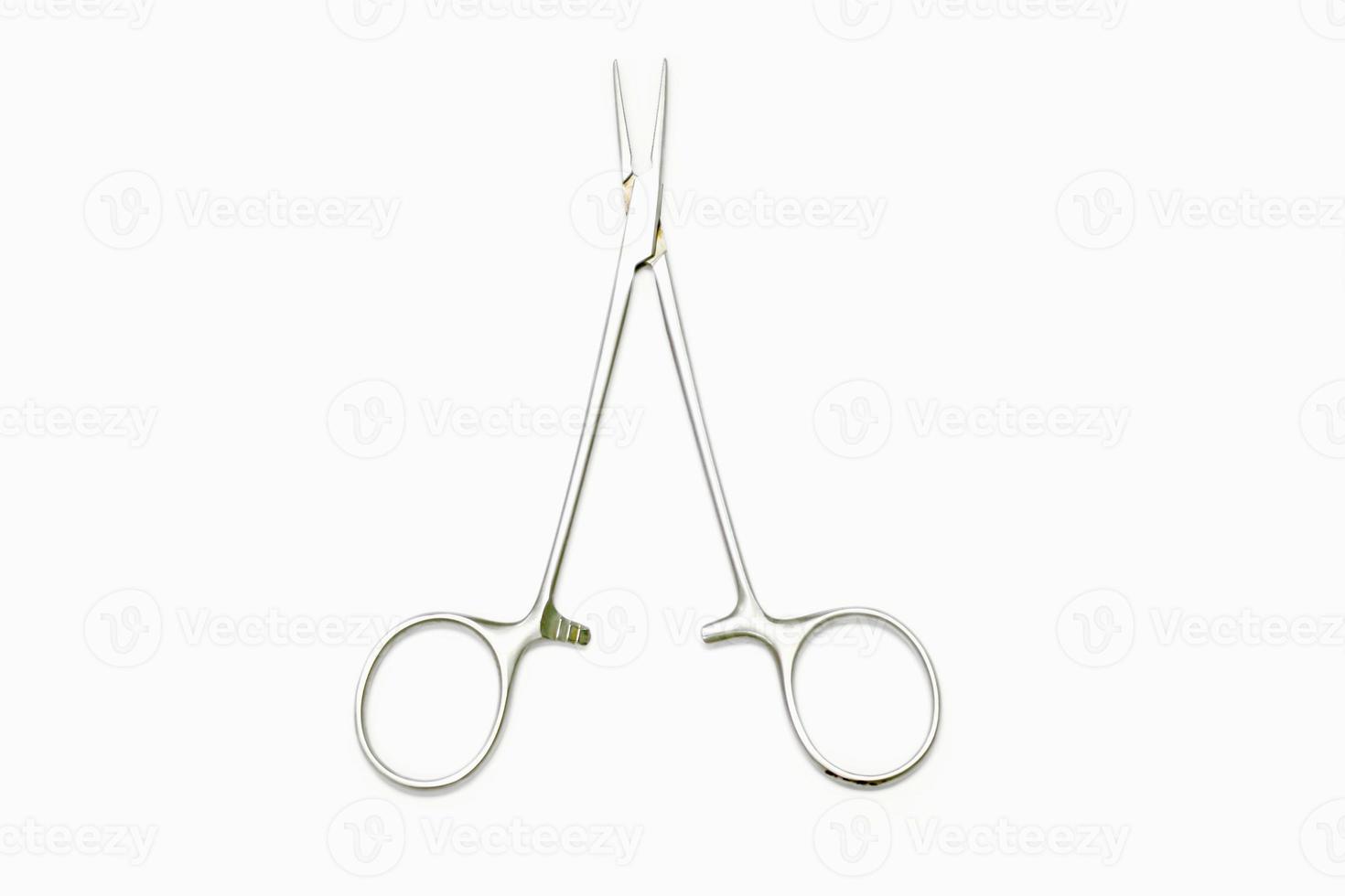 Top view of Medical atery clamp scissor for clamp of veins to stop the bleeding isolate on white background. photo