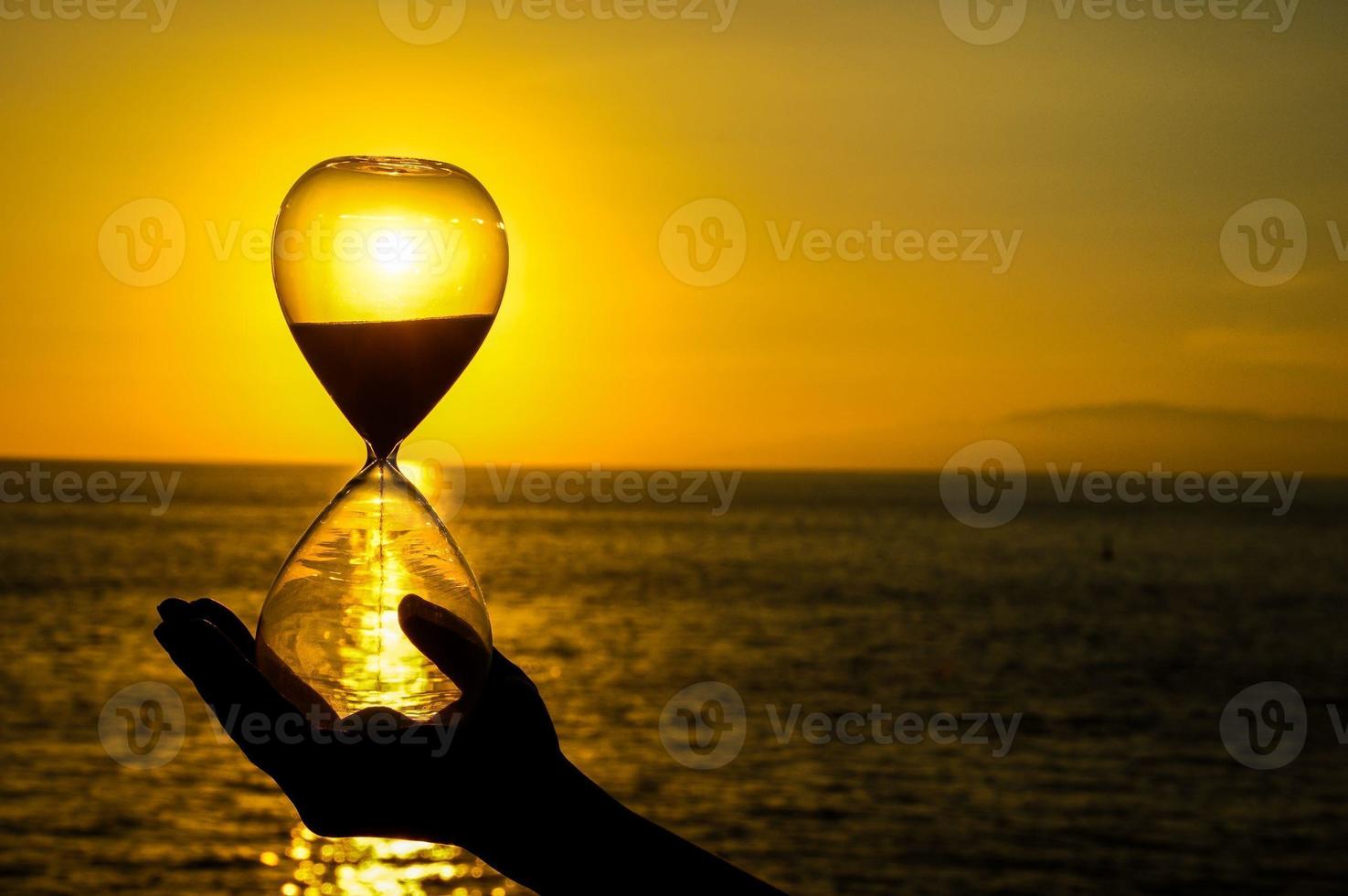 Hourglass and sunset photo