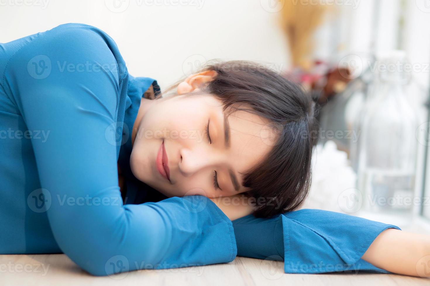 Beautiful portrait young asian woman smiling sleep at cafe, model girl happy with relax and resting, female lying, lifestyle concept. photo