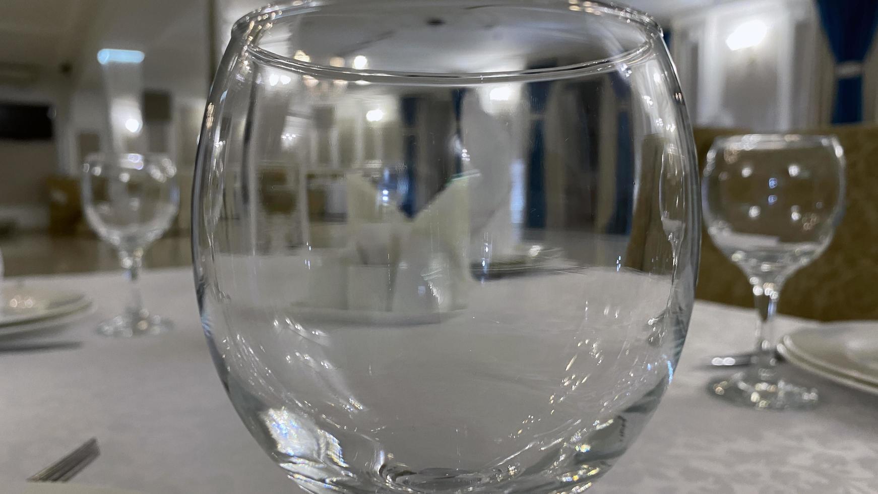 View of the room through a glass glass on the table photo