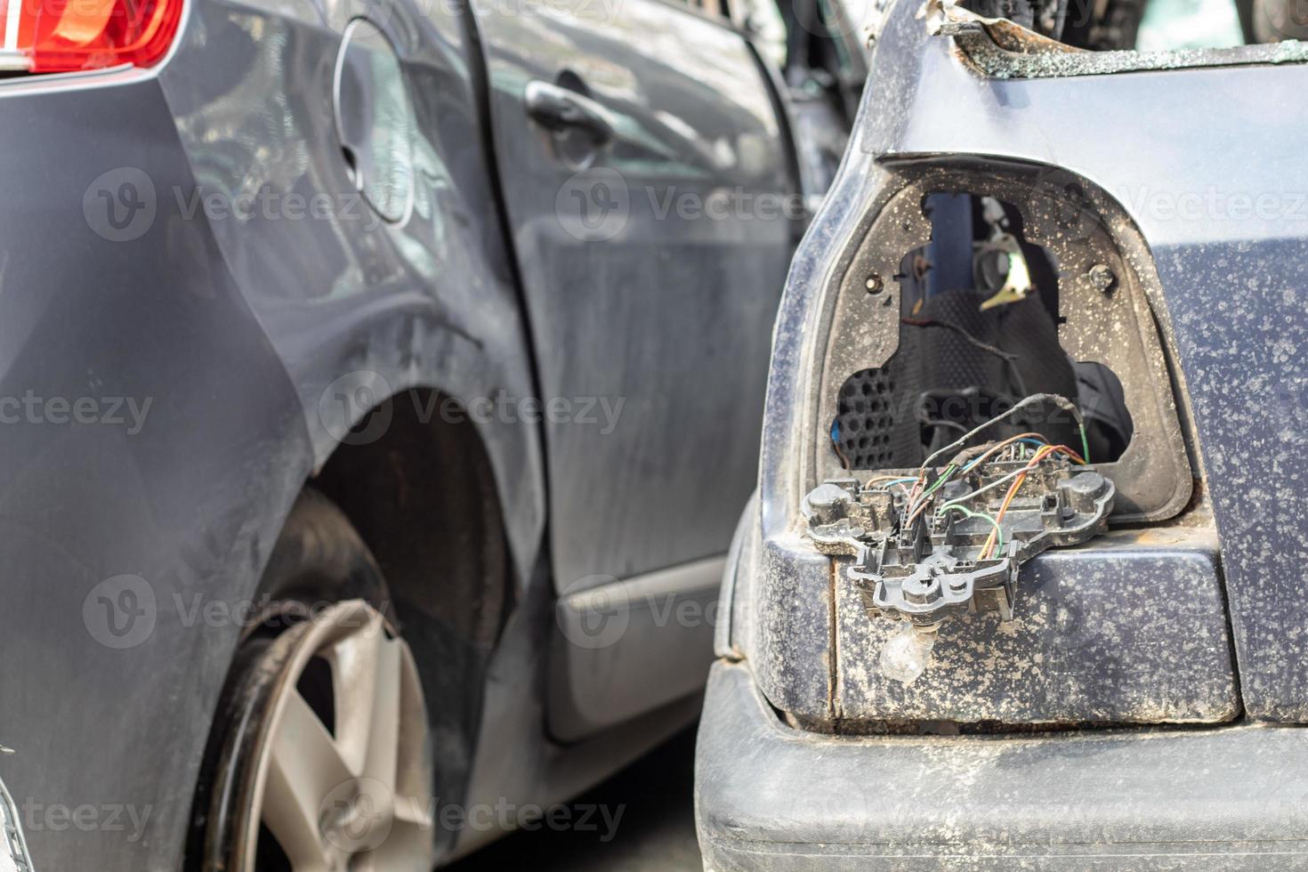 Many broken cars after a traffic accident in the parking lot of a  restoration service station on the street. Car body damage workshop  outdoors. Sale of insurance emergency vehicles at auction. 8280684