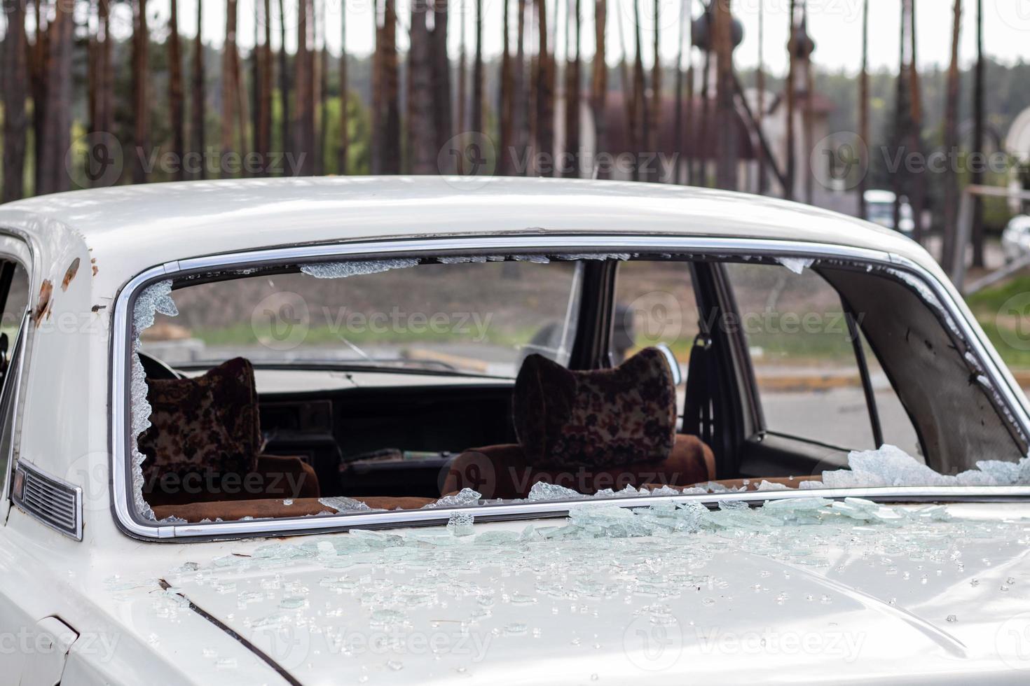 A car after an accident with a broken rear window. Broken window in a vehicle. The wreckage of the interior of a modern car after an accident, a detailed close-up view of the damaged car. photo