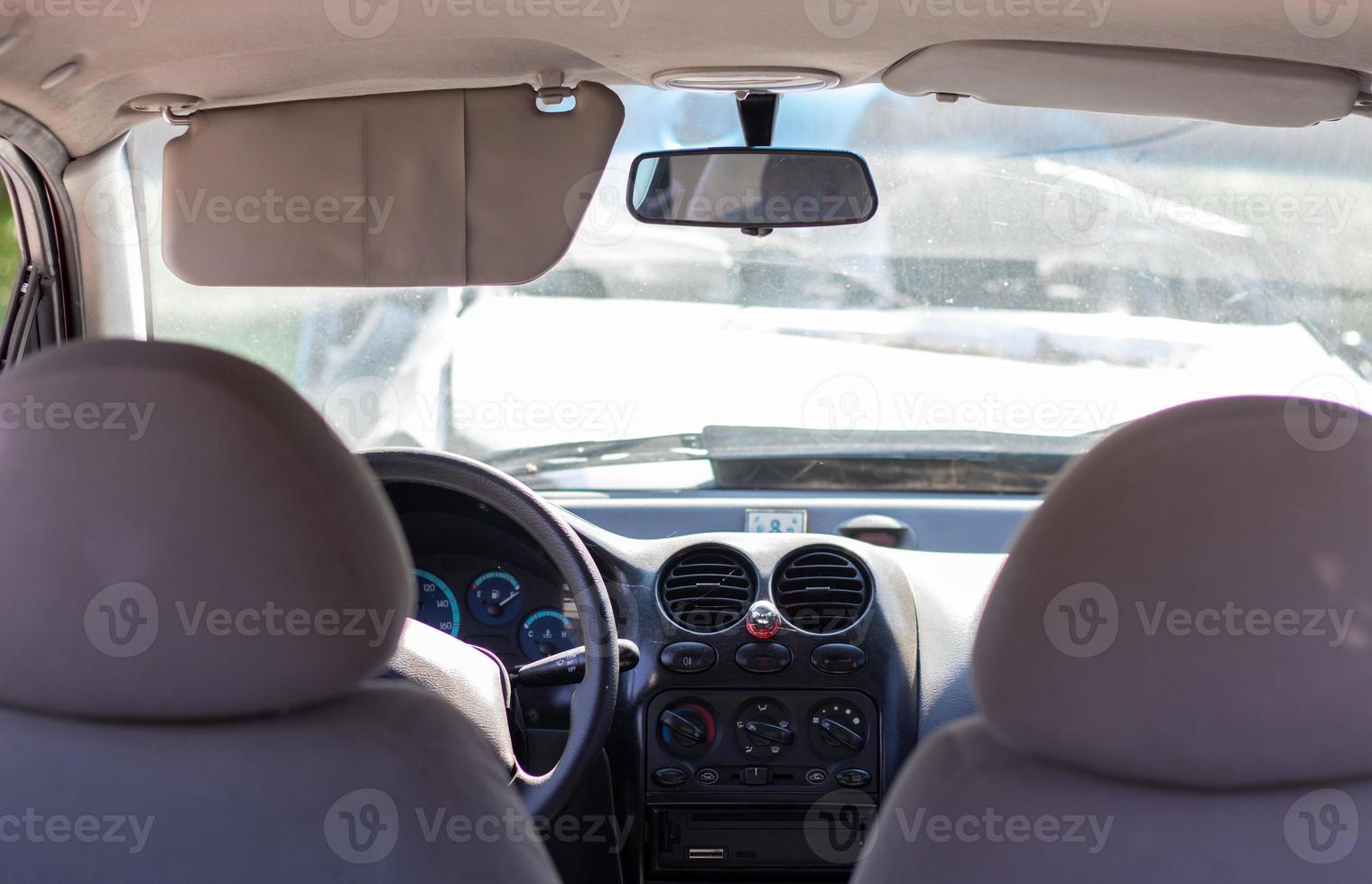 Damaged car window after an accident. Broken windshield as a result of an accident, inside view. Cabin interior details, view from the cab. Safe movement. Broken windshield. Glass crack and damage. photo