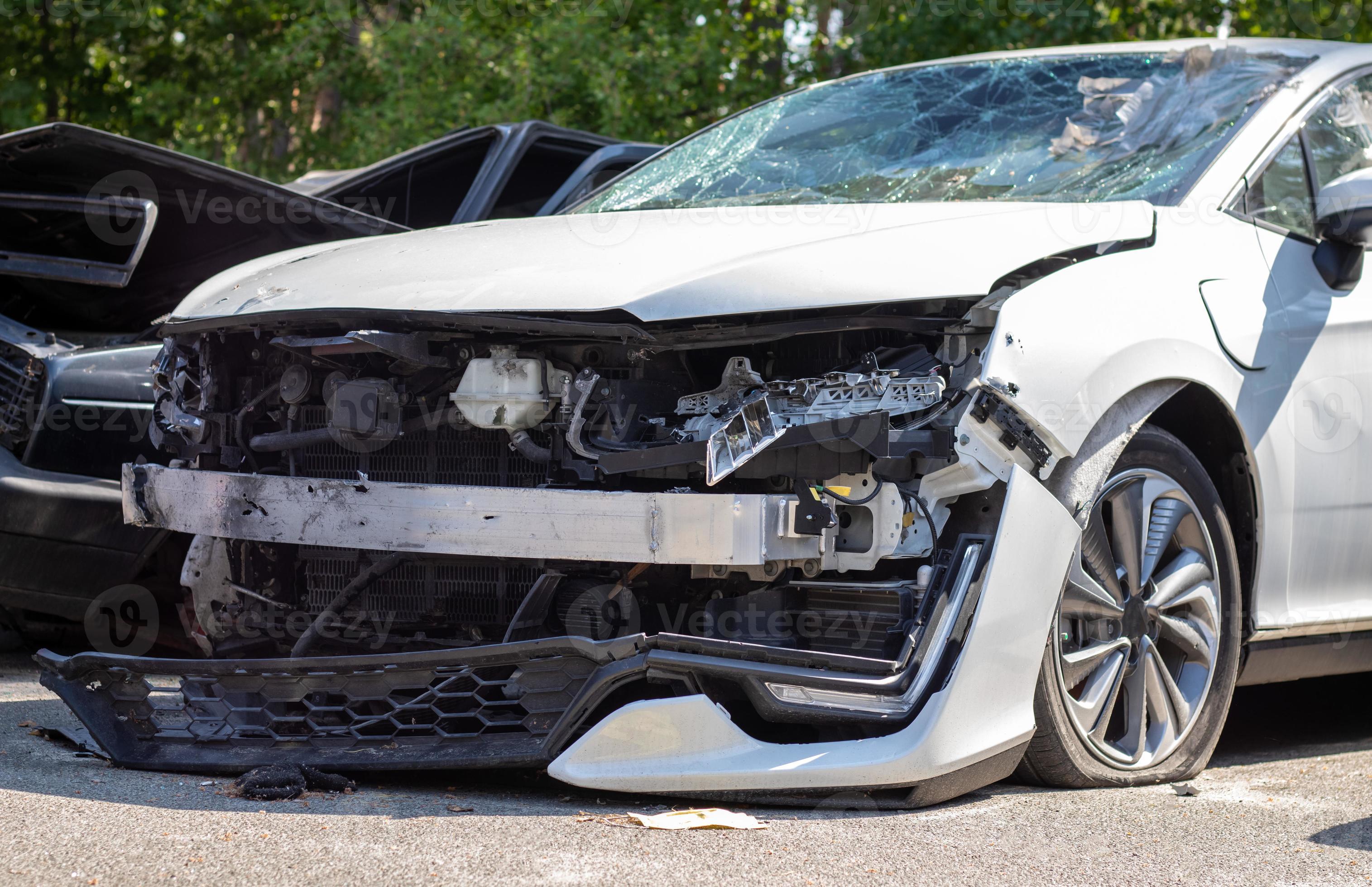 Many broken cars after a traffic accident in the parking lot of a  restoration service station on the street. Car body damage workshop  outdoors. Sale of insurance emergency vehicles at auction. 8281183