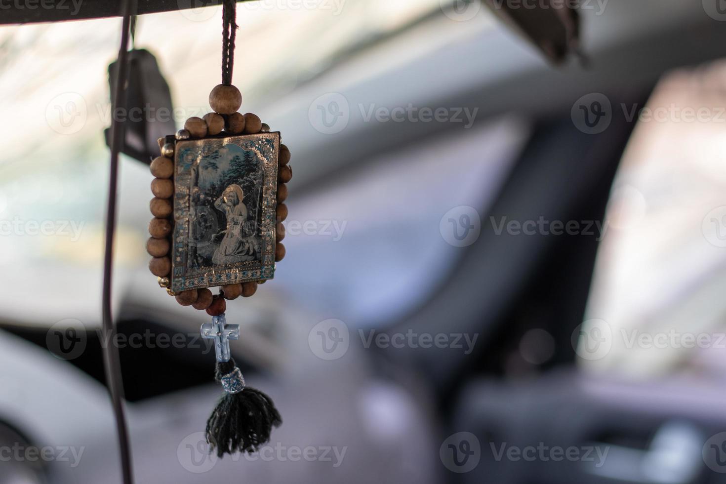 The icon amulet in the car of Nicholas the Wonderworker on a cord. The badge hangs conveniently on the rear-view mirror in the car. Translation Seraphim of Sarov the Wonderworker. photo