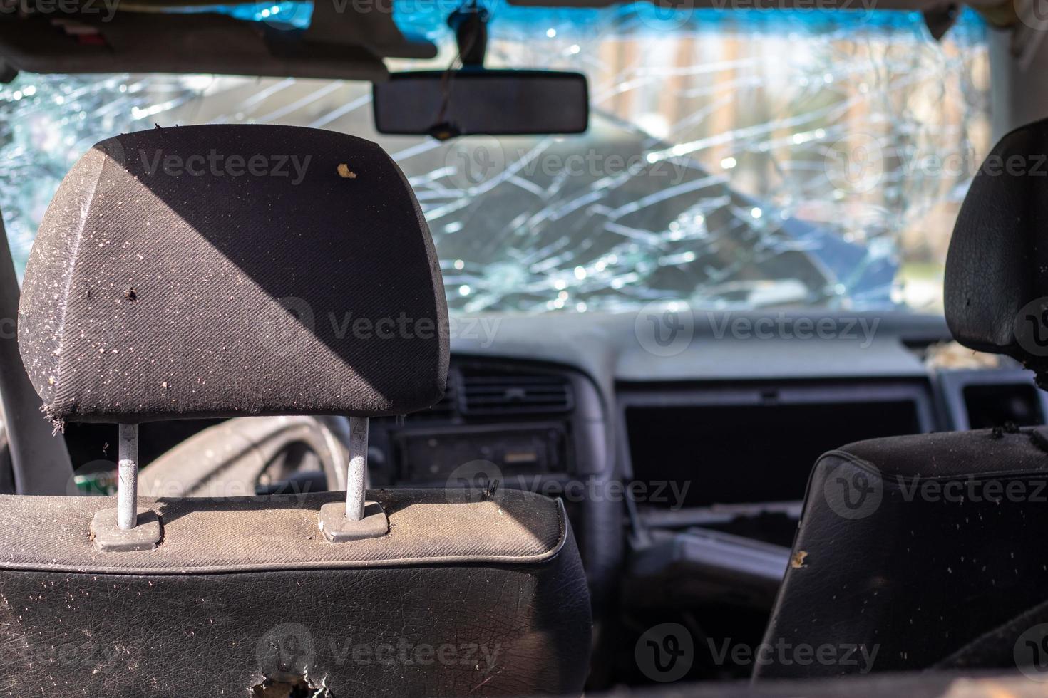 Damaged car window after an accident. Broken windshield as a result of an accident, inside view. Cabin interior details, view from the cab. Safe movement. Broken windshield. Glass crack and damage. photo