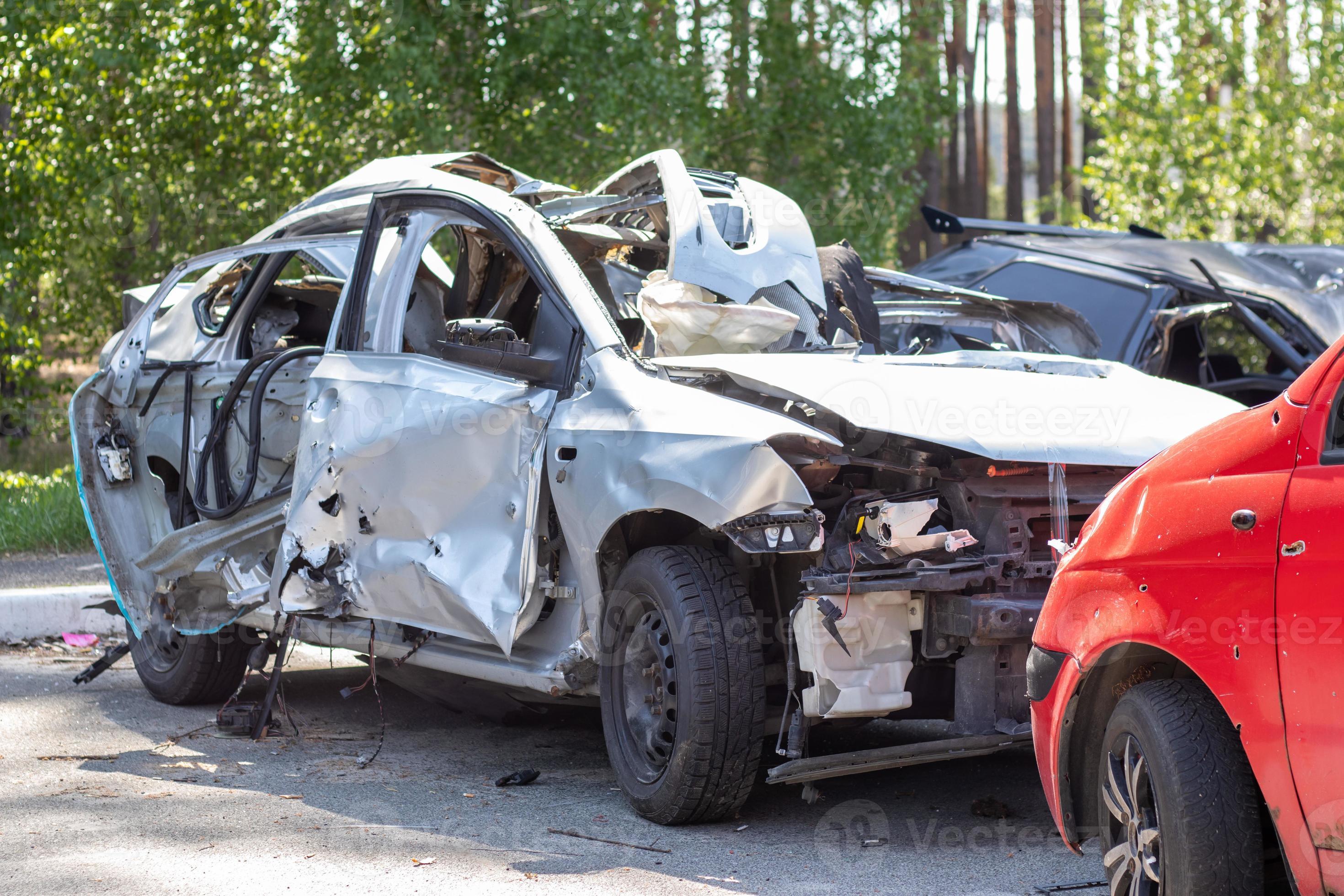 Many broken cars after a traffic accident in the parking lot of a  restoration service station on the street. Car body damage workshop  outdoors. Sale of insurance emergency vehicles at auction. 8281183